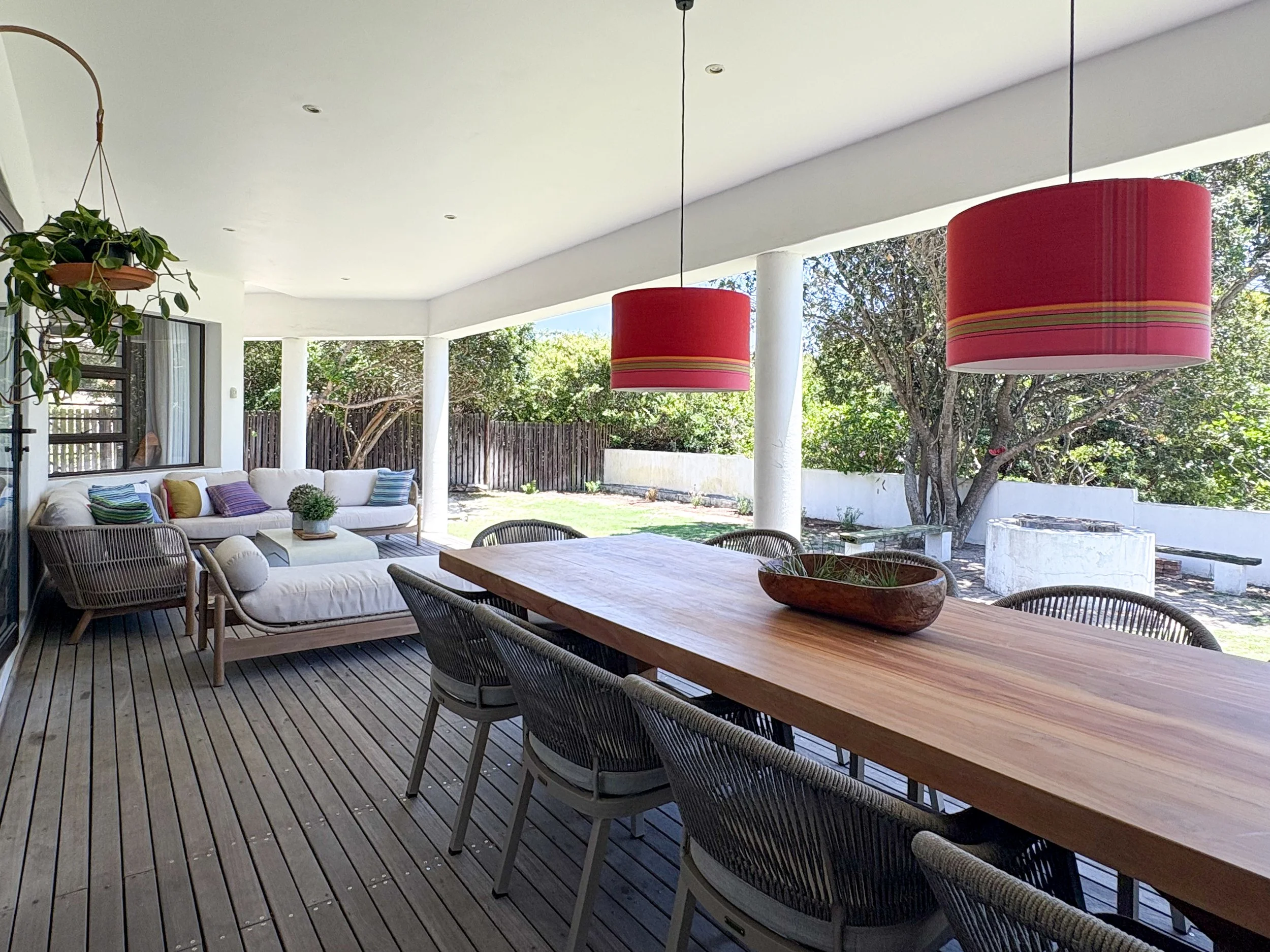 Patio lounge and dining area, garden and boundary wall visible beyond