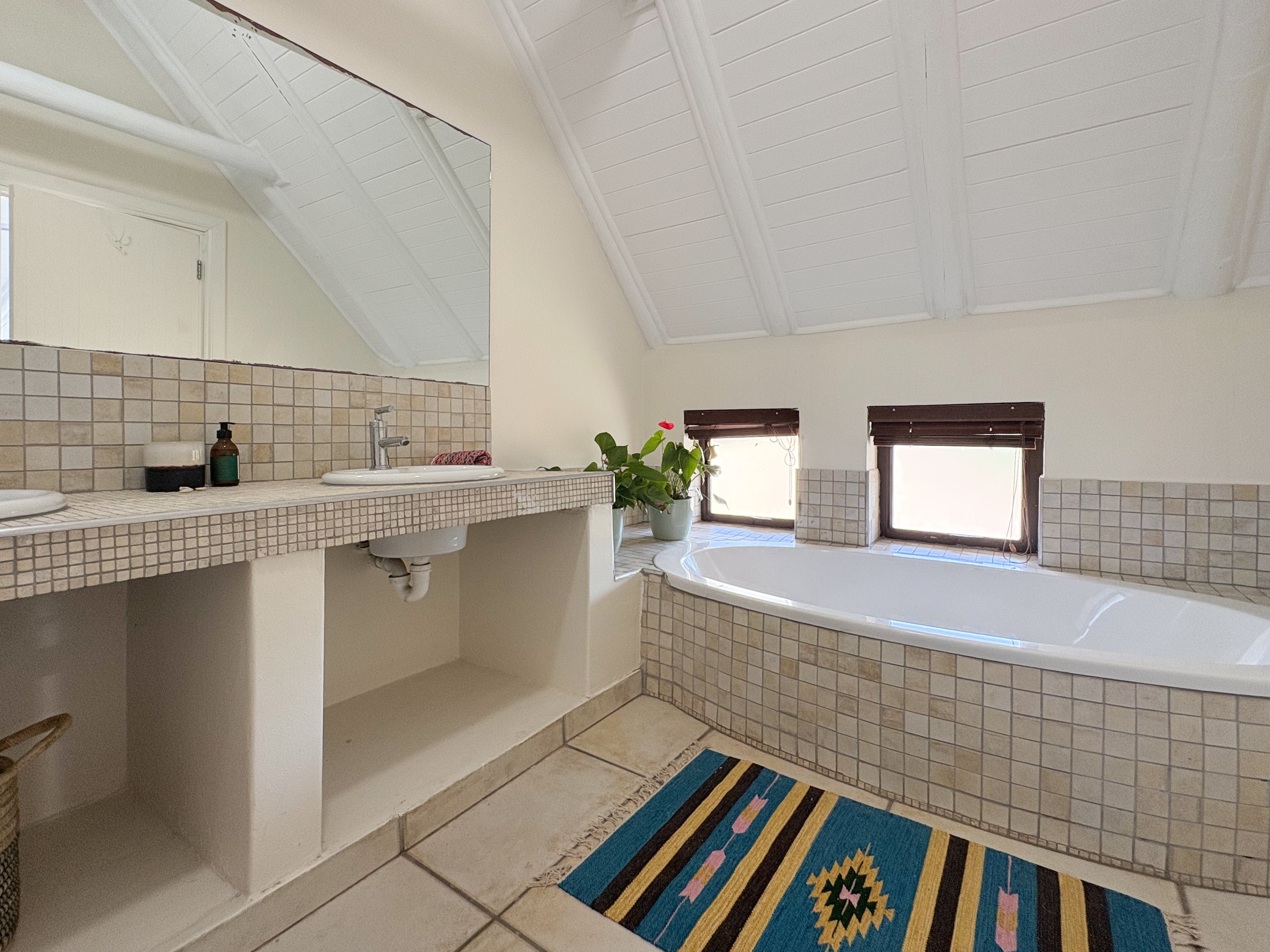En-suite bathroom with freestanding bath and garden-facing windows
