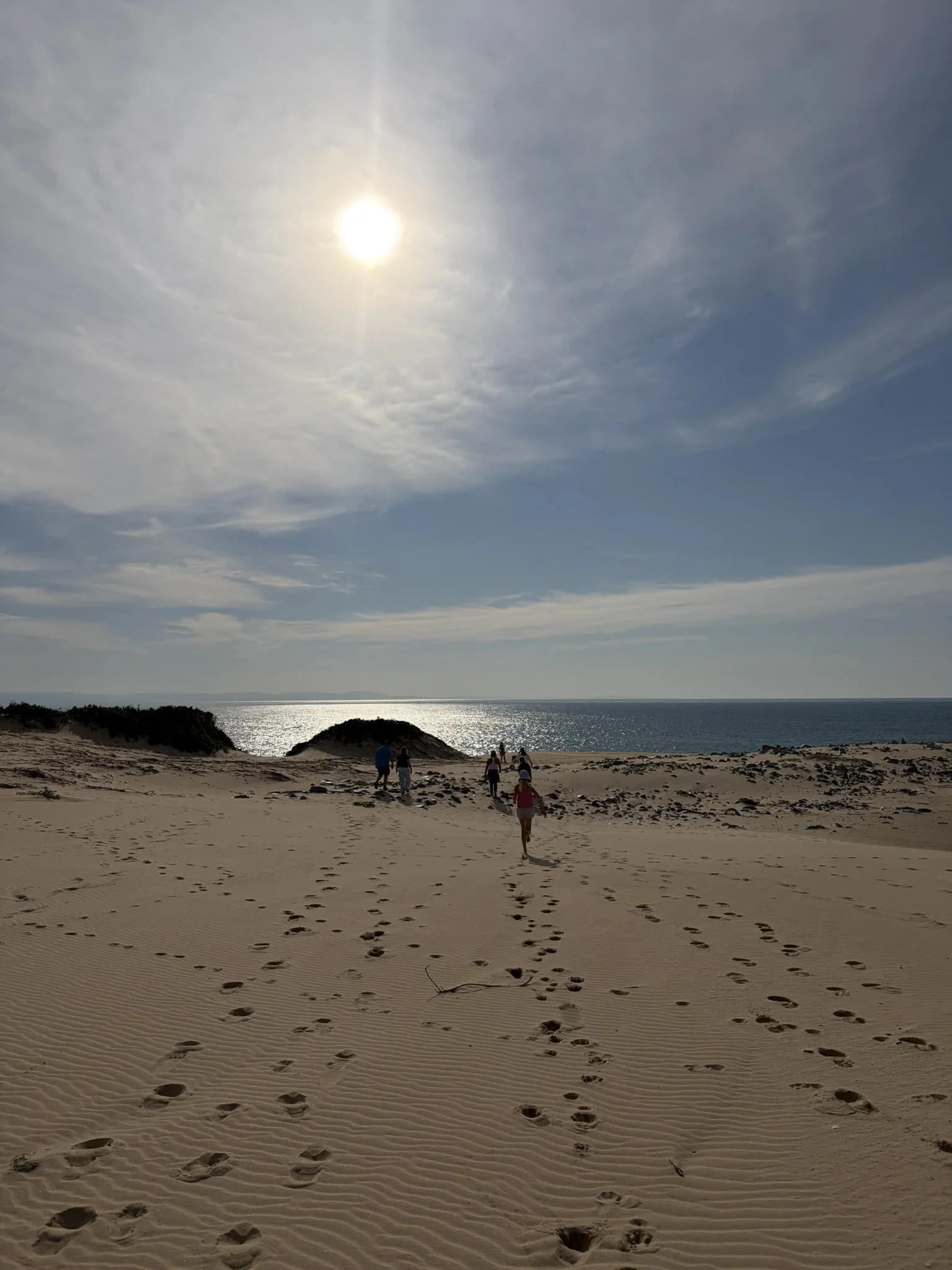 kids running down a sunlit dune