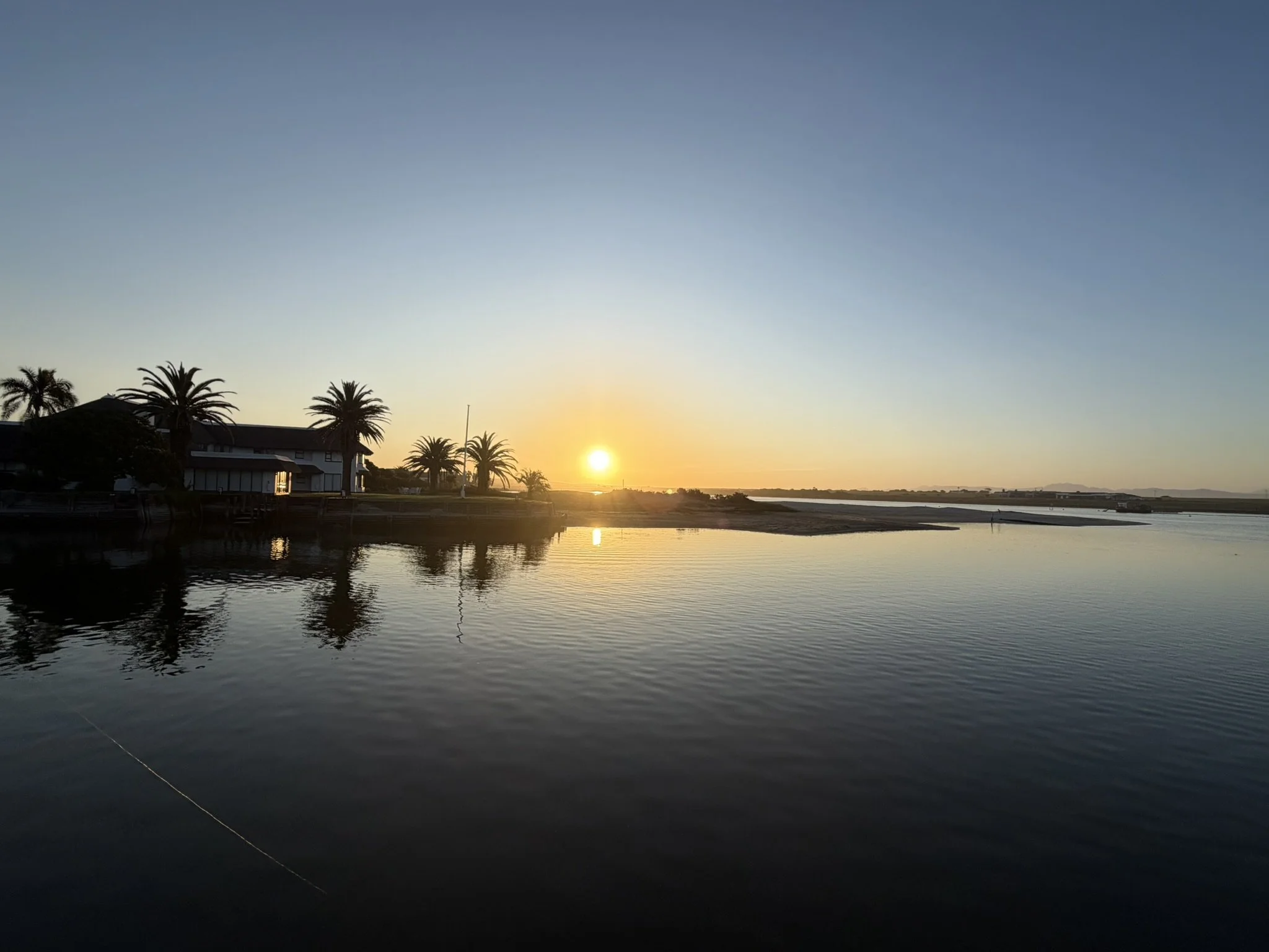 sunset over the canal, palm trees silhouetted