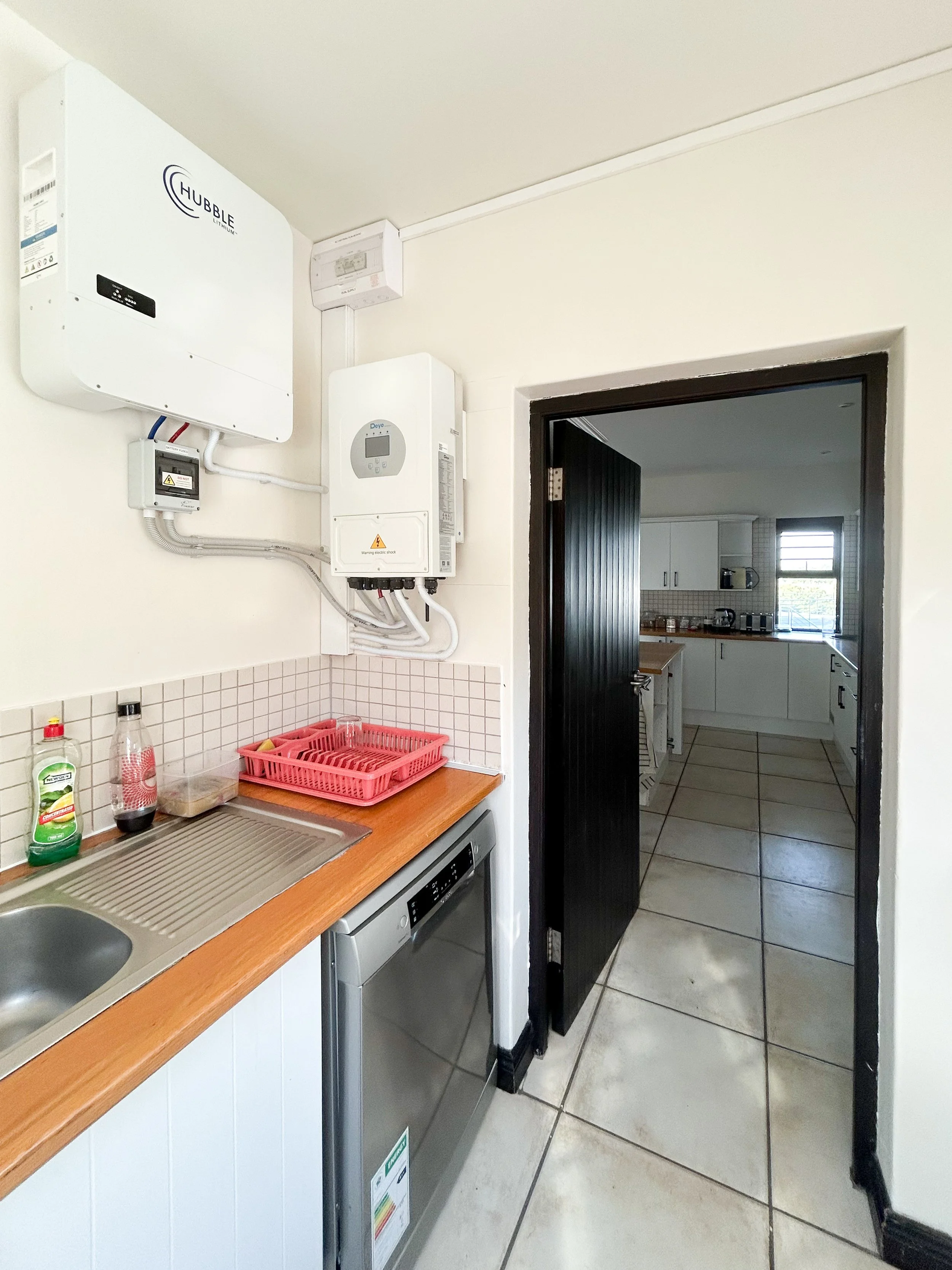 Scullery entrance door showing solar system and kitchen