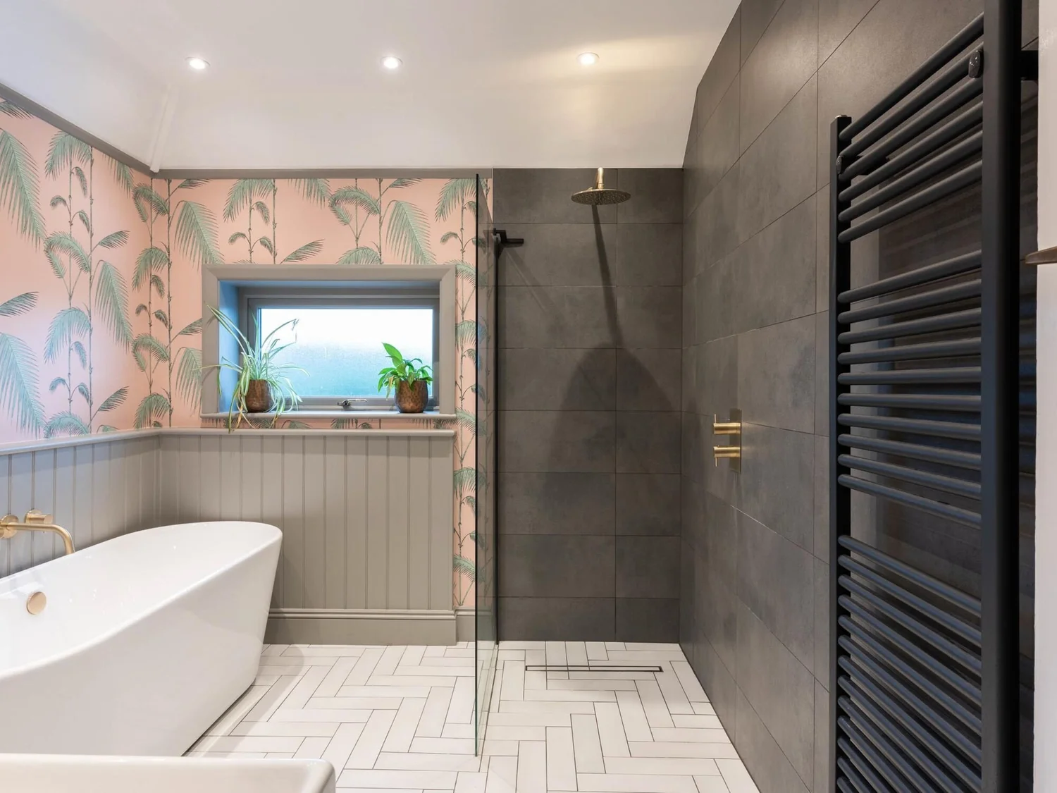 Large grey porcelain tiles fitted around a bath and walk-in shower