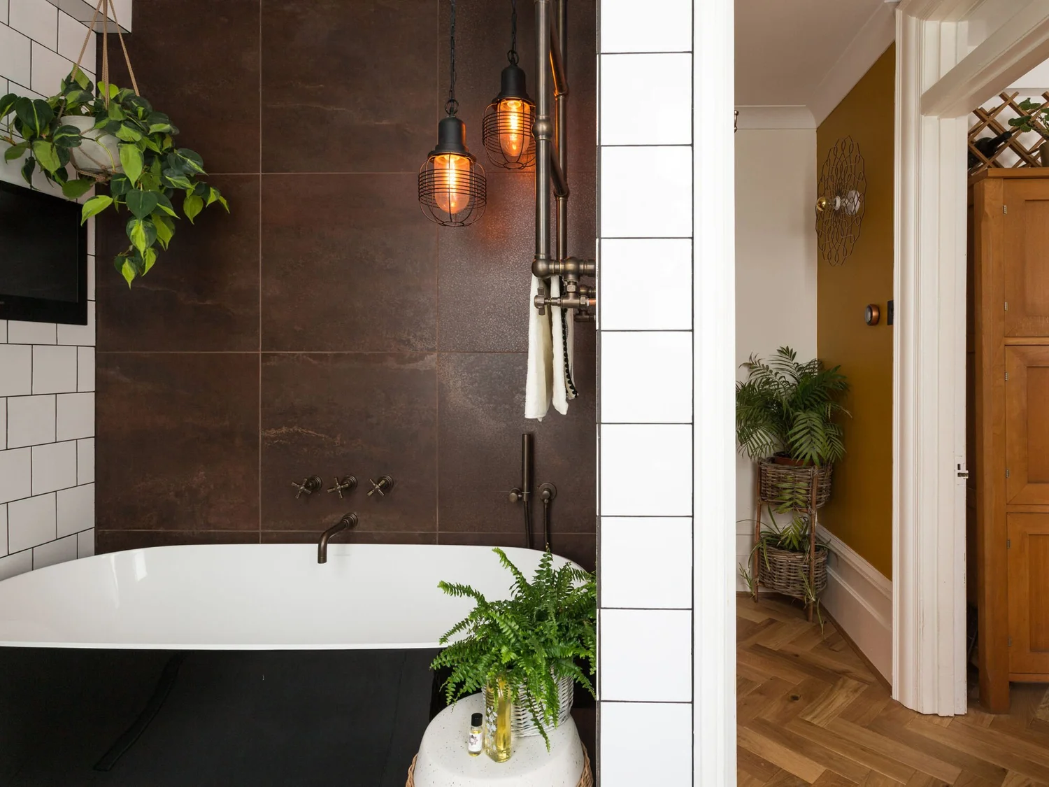 Dark porcelain wall tiles installed around a residential bath and shower