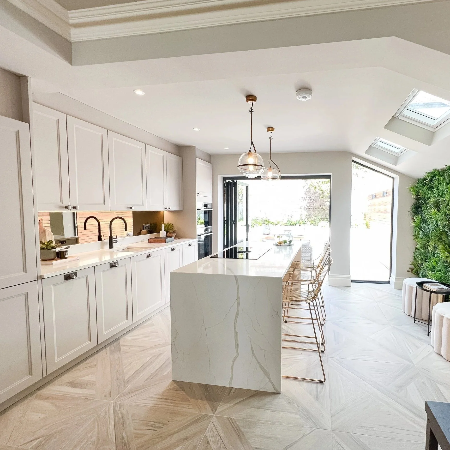 Completed open-plan kitchen with island, fitted cabinetry and rooflights