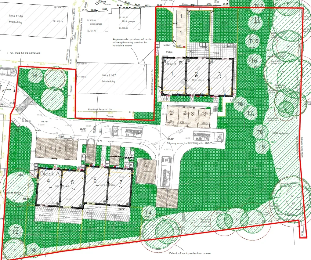 Architectural site plan showing numbered residential buildings, green spaces with trees, parking areas, and garden features outlined with detailed measurements and annotations.