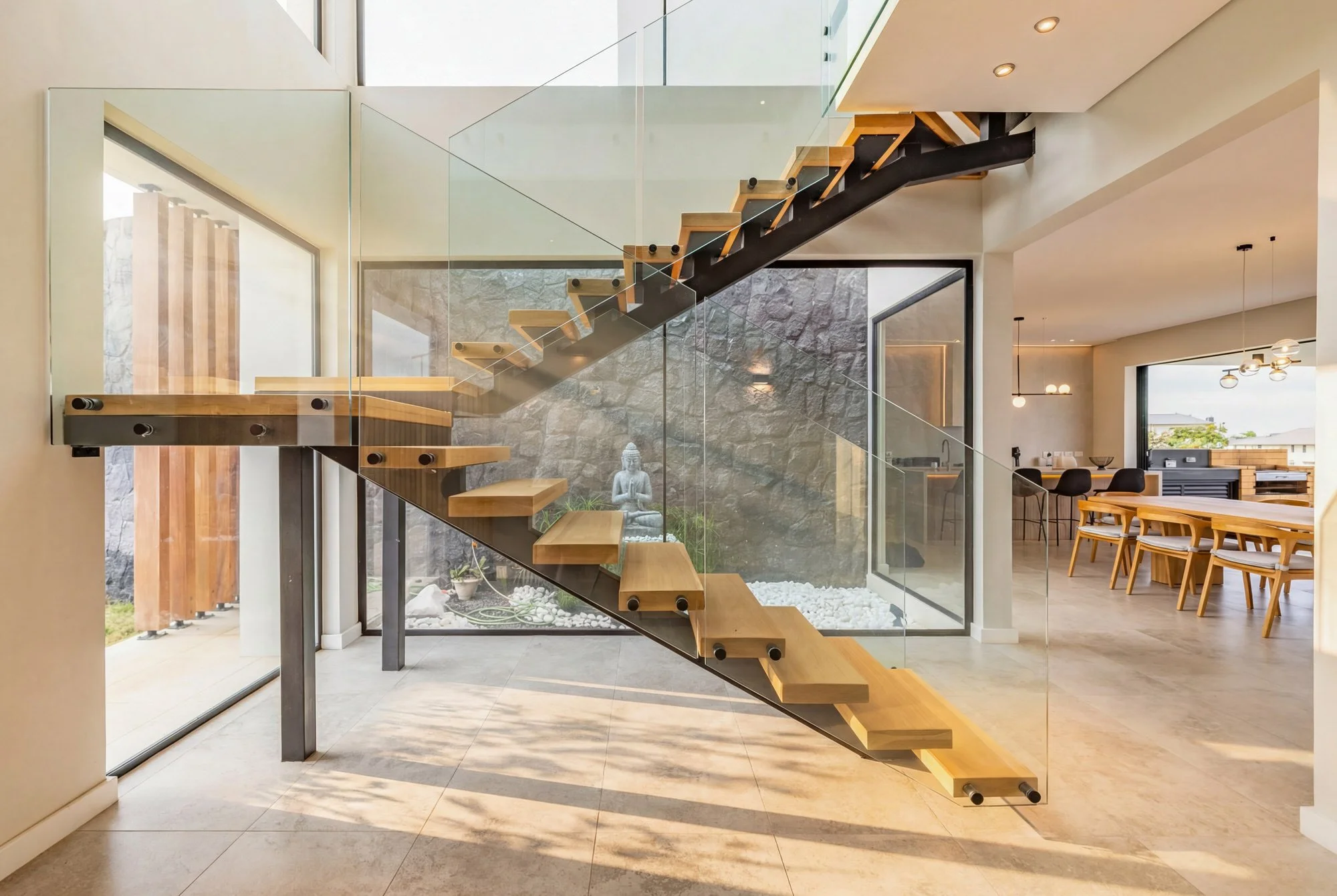 Chikooree House — floating timber staircase, glass and natural light.