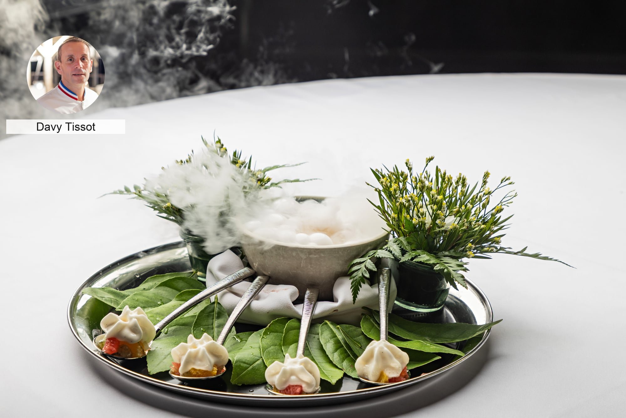 Botanical amuse-bouche presentation by chef Davy Tissot at a gastronomy event.