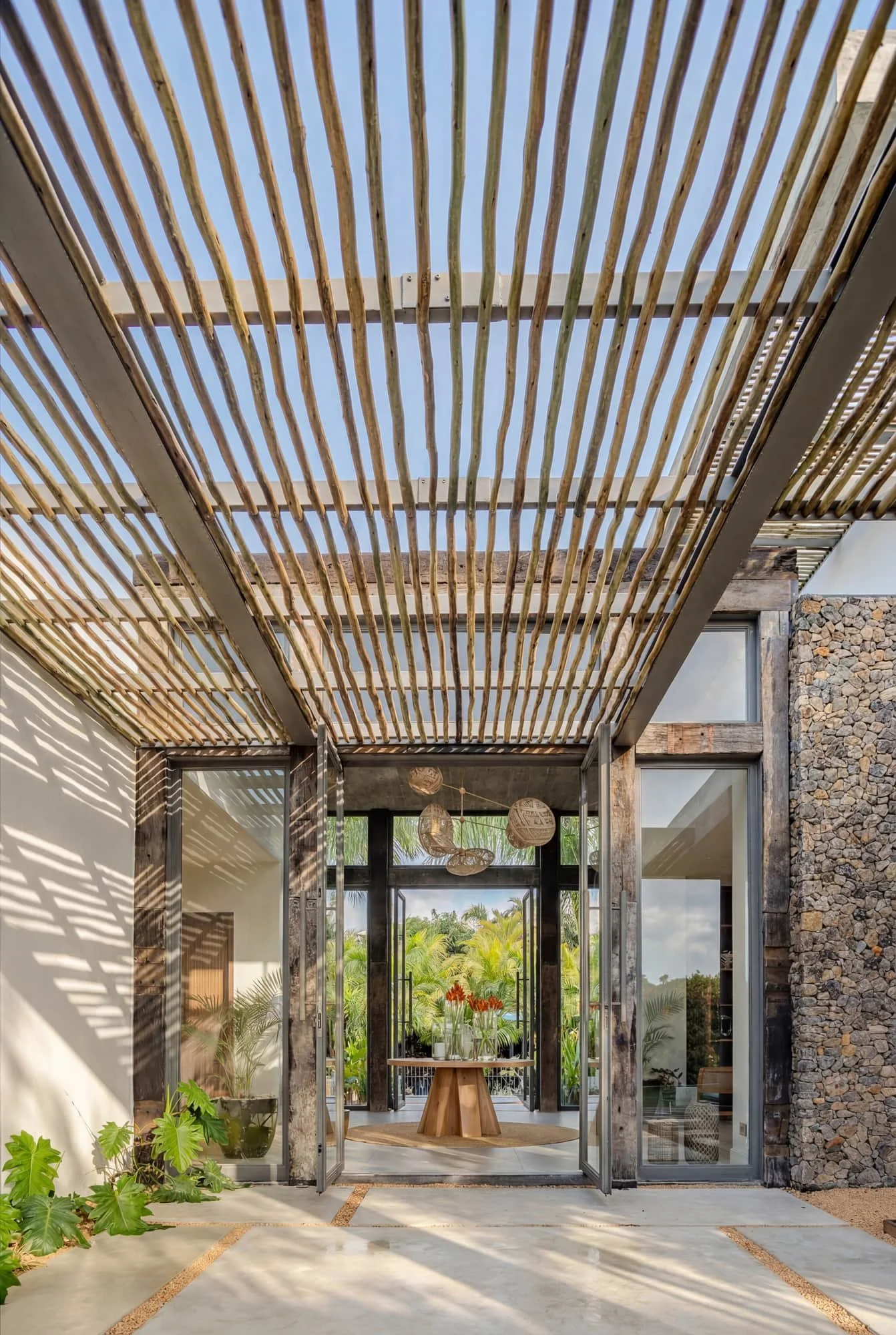Villa Anahita H15 — entrance perspective beneath a slatted pergola.