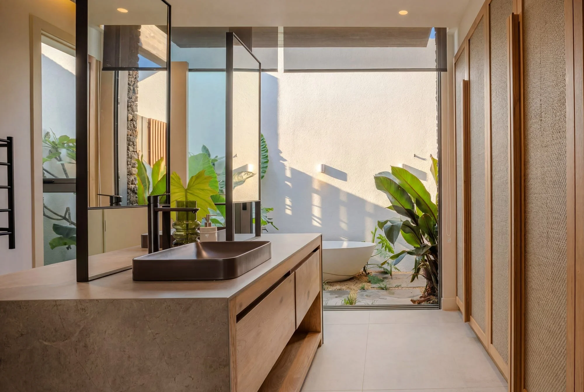 Villa Anahita H15 — bathroom with natural light and an outdoor courtyard.