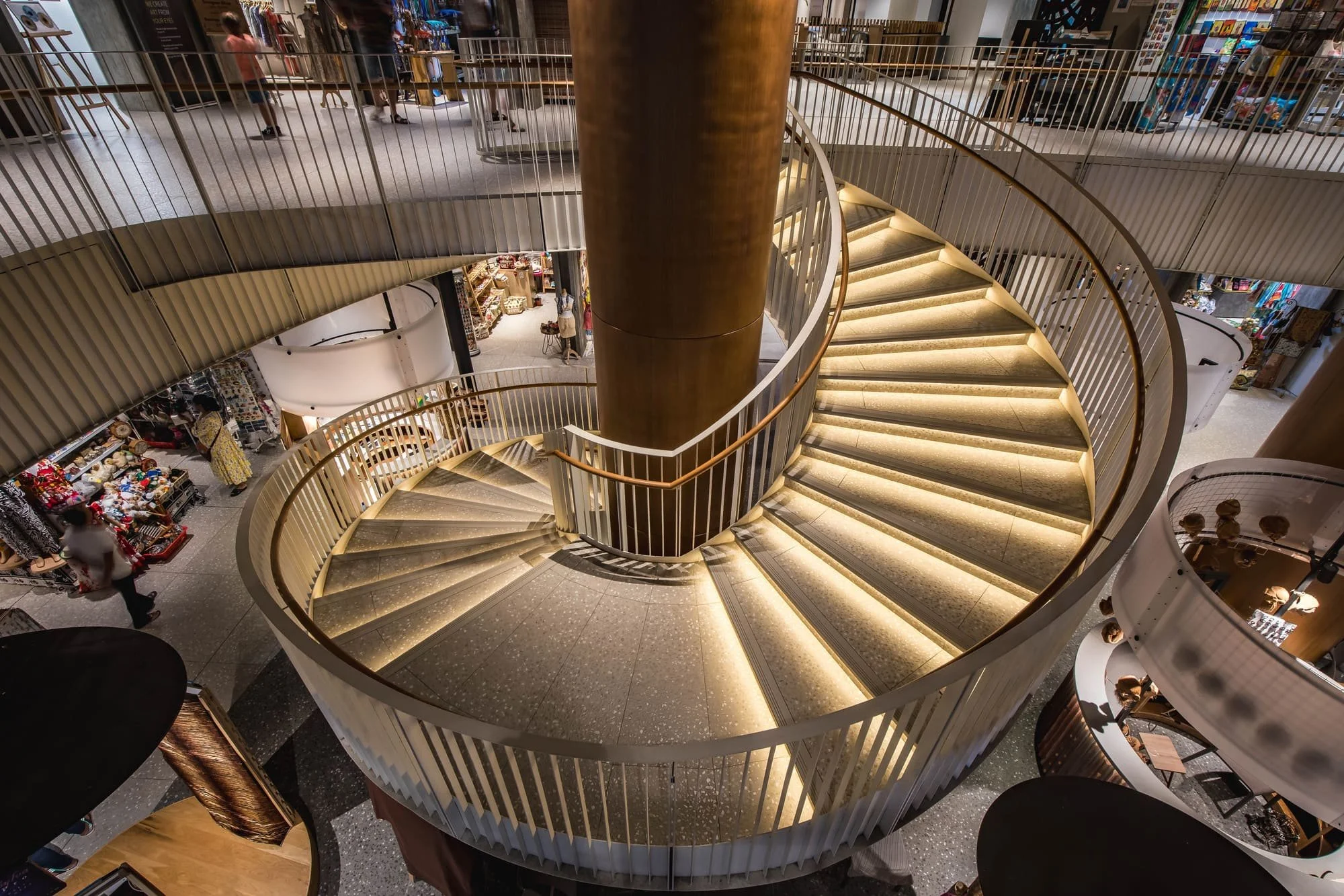 Le Caudan — sculptural illuminated staircase viewed from above.