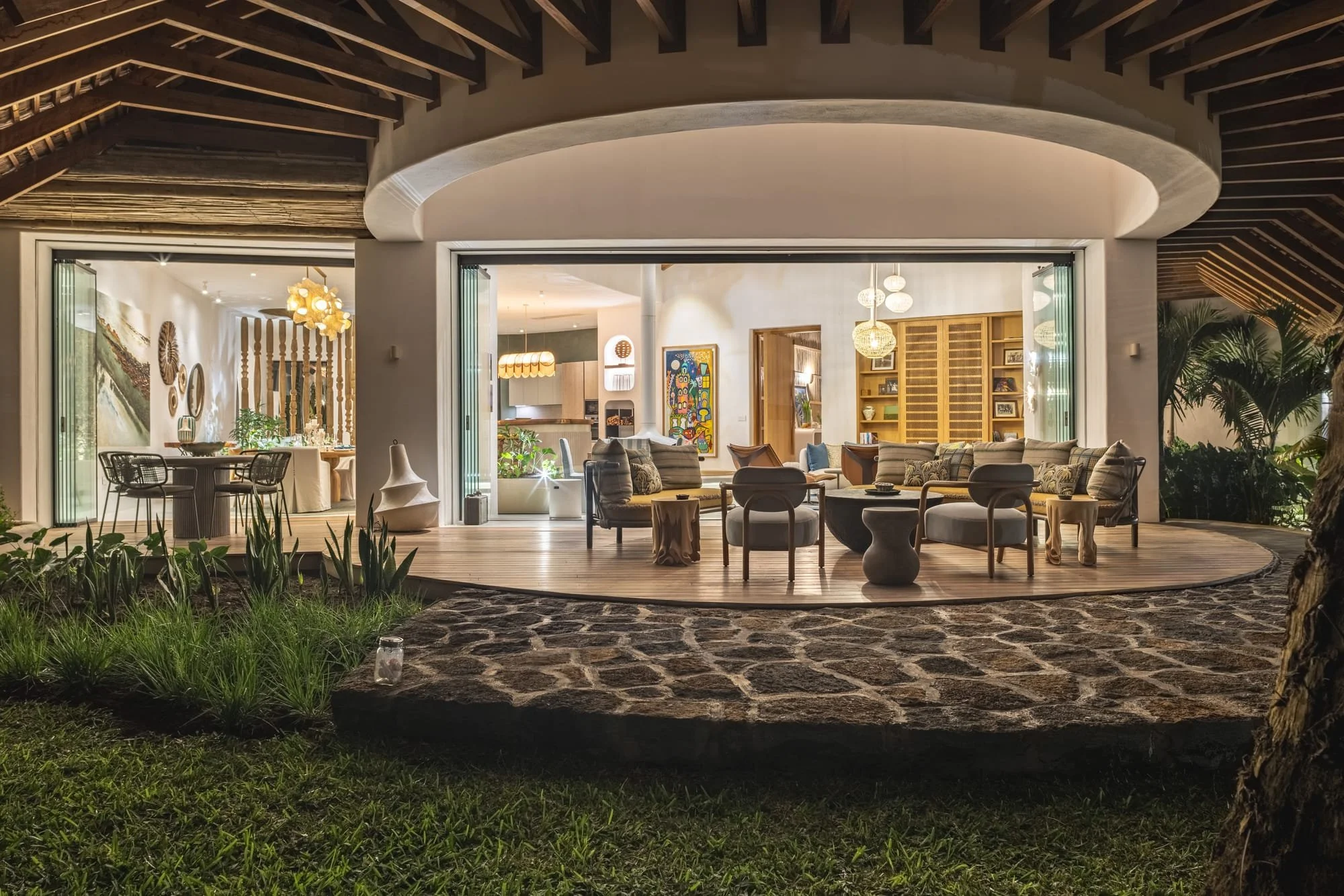 Muse Villa, Mauritius — illuminated veranda beneath a timber roof.