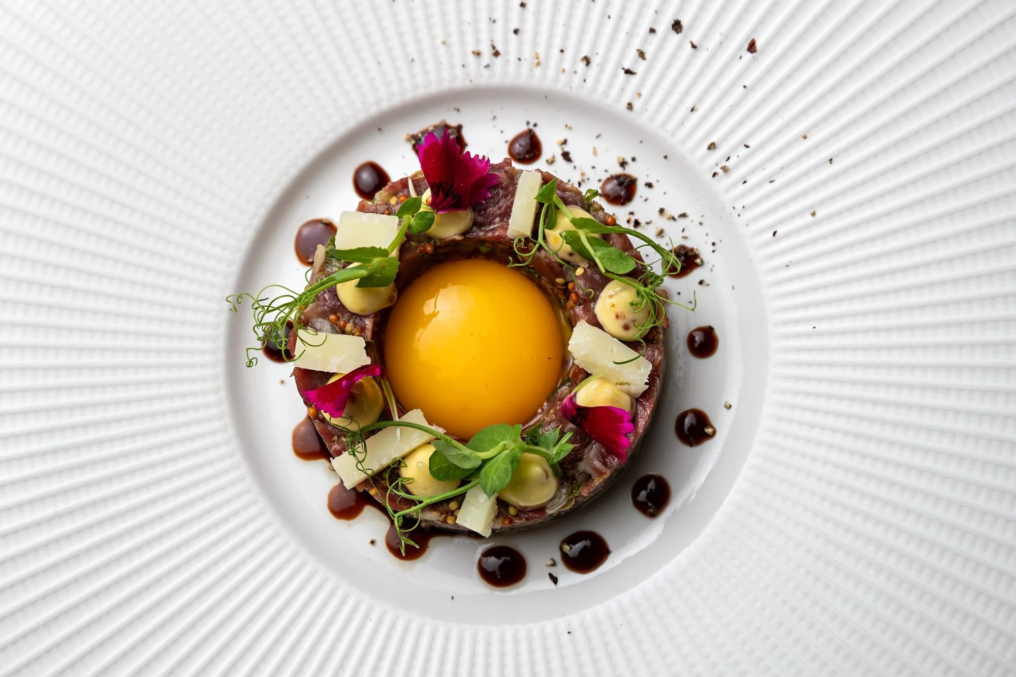 Colourful gourmet plating with a yellow centre by chef Yann Monbaron.