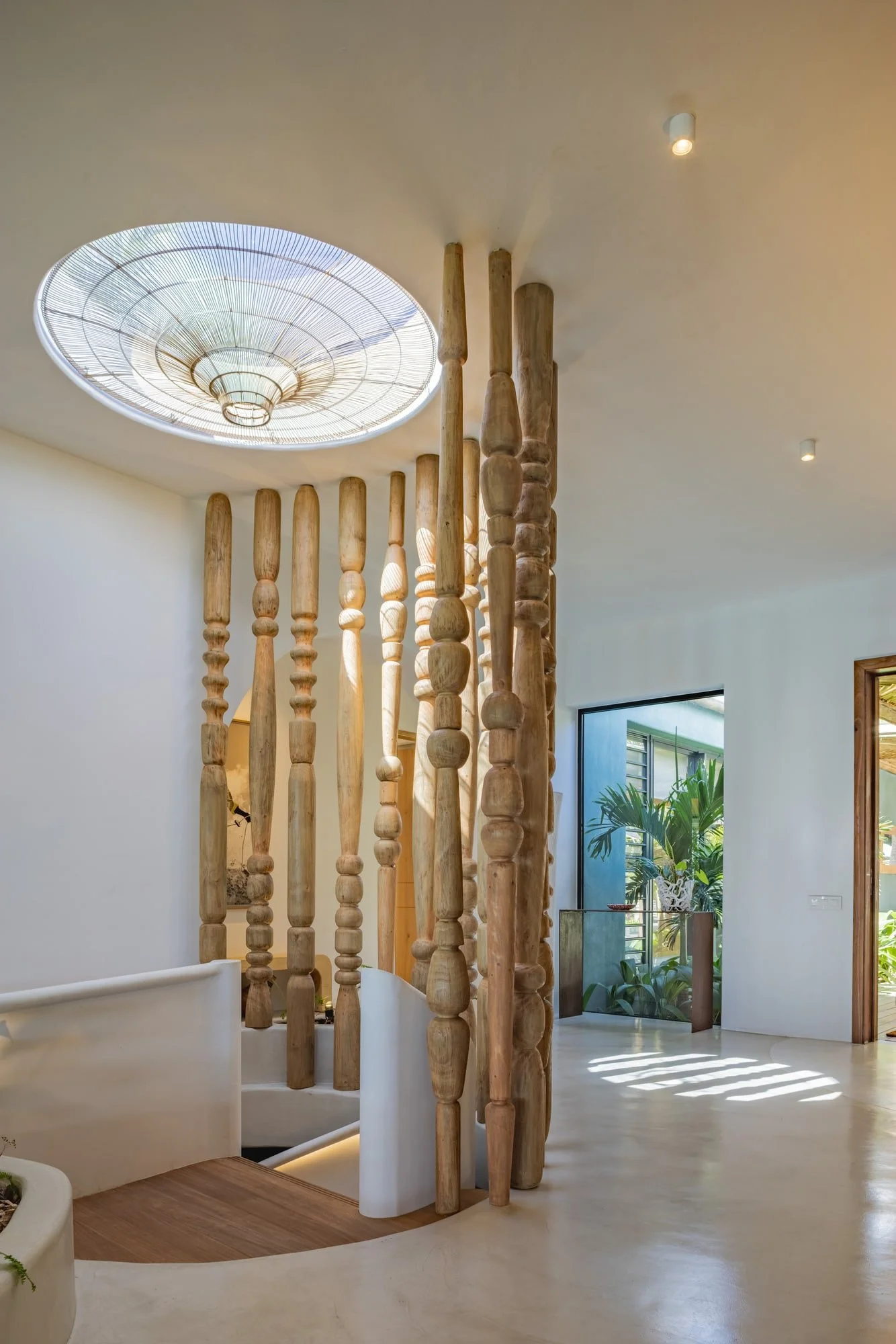 Muse Villa — sculptural timber columns beneath a circular skylight.