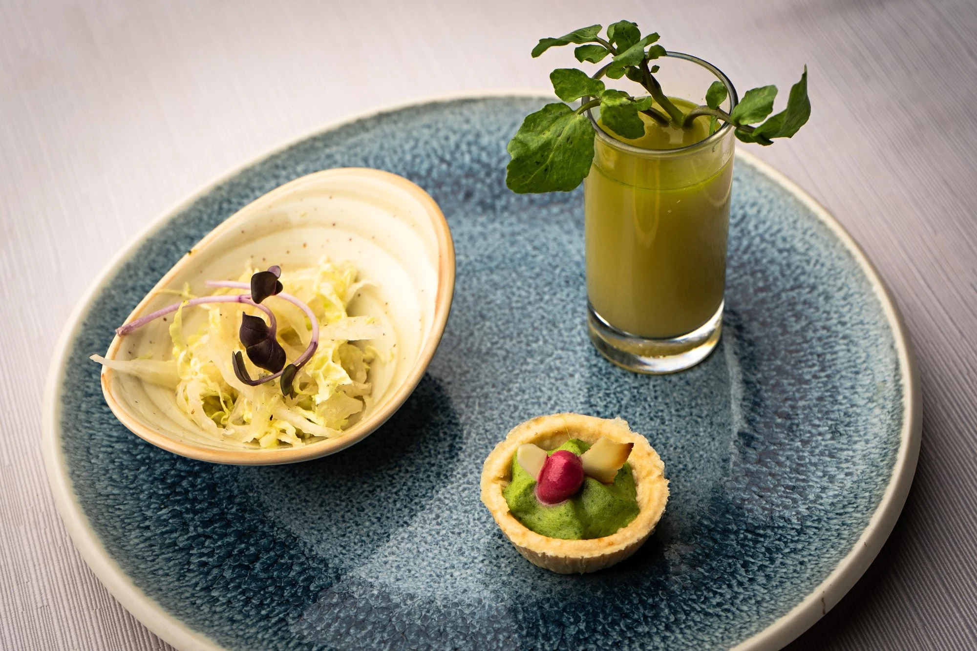 Trio of refined amuse-bouches arranged for a gastronomy presentation.