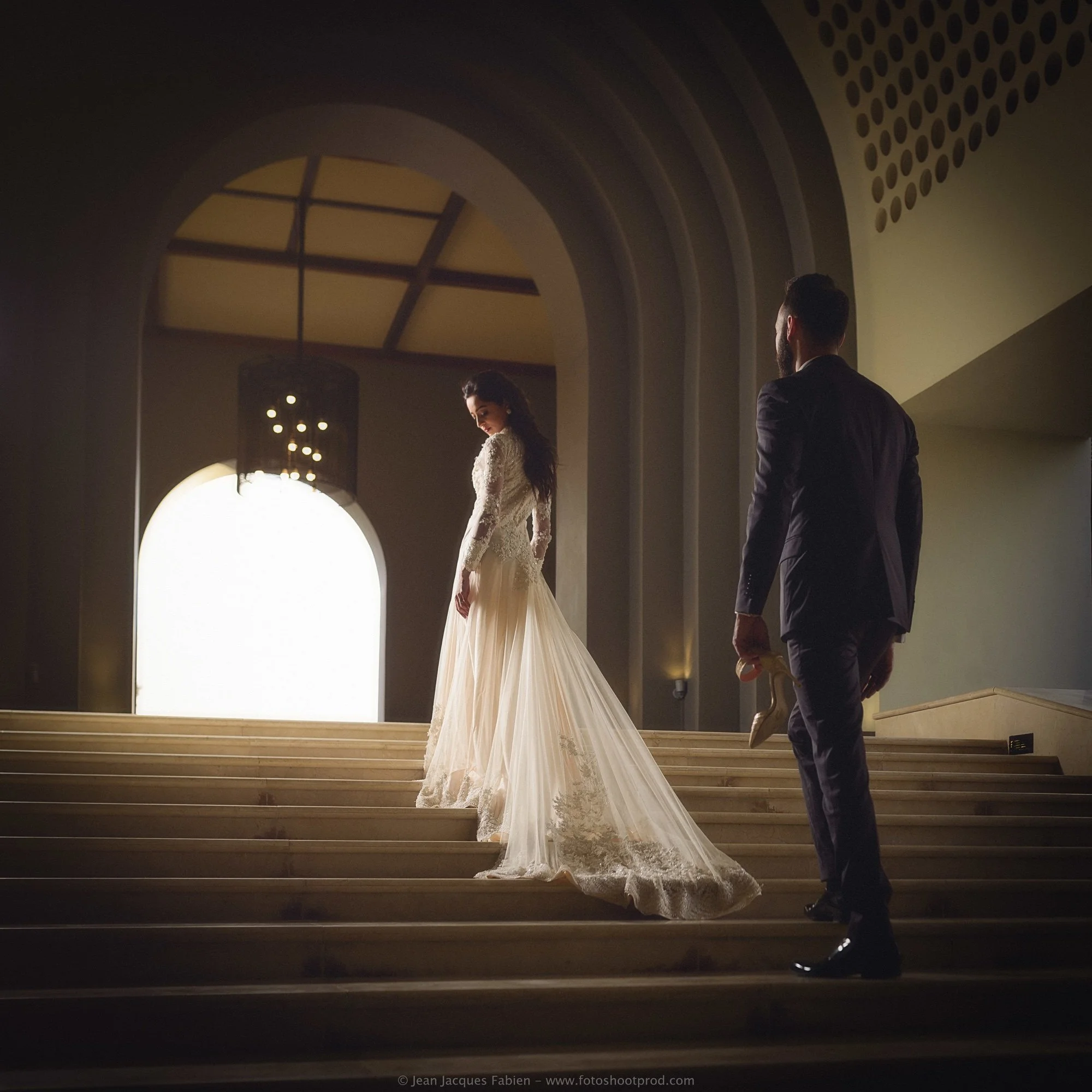 Cinematic wedding portrait of Zaynab and Tariq on a grand staircase in Mauritius.