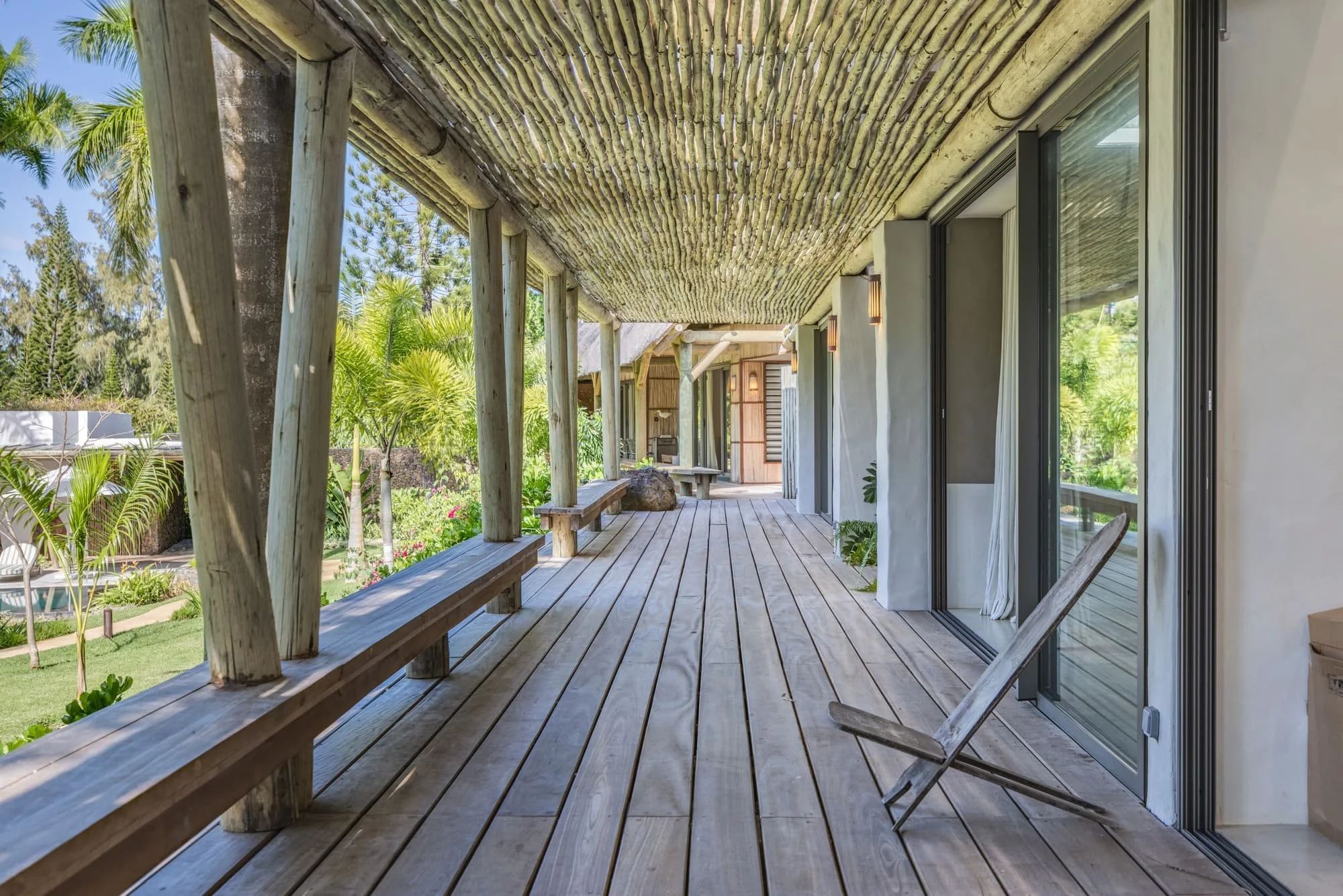 Muse Villa — timber veranda with a strong architectural perspective.