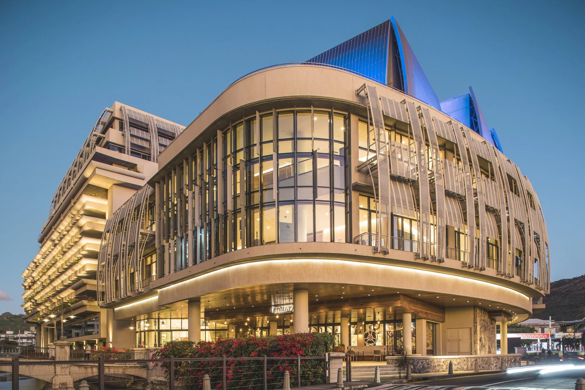 Caudan Arts Centre, Mauritius — illuminated curved facade at dusk.