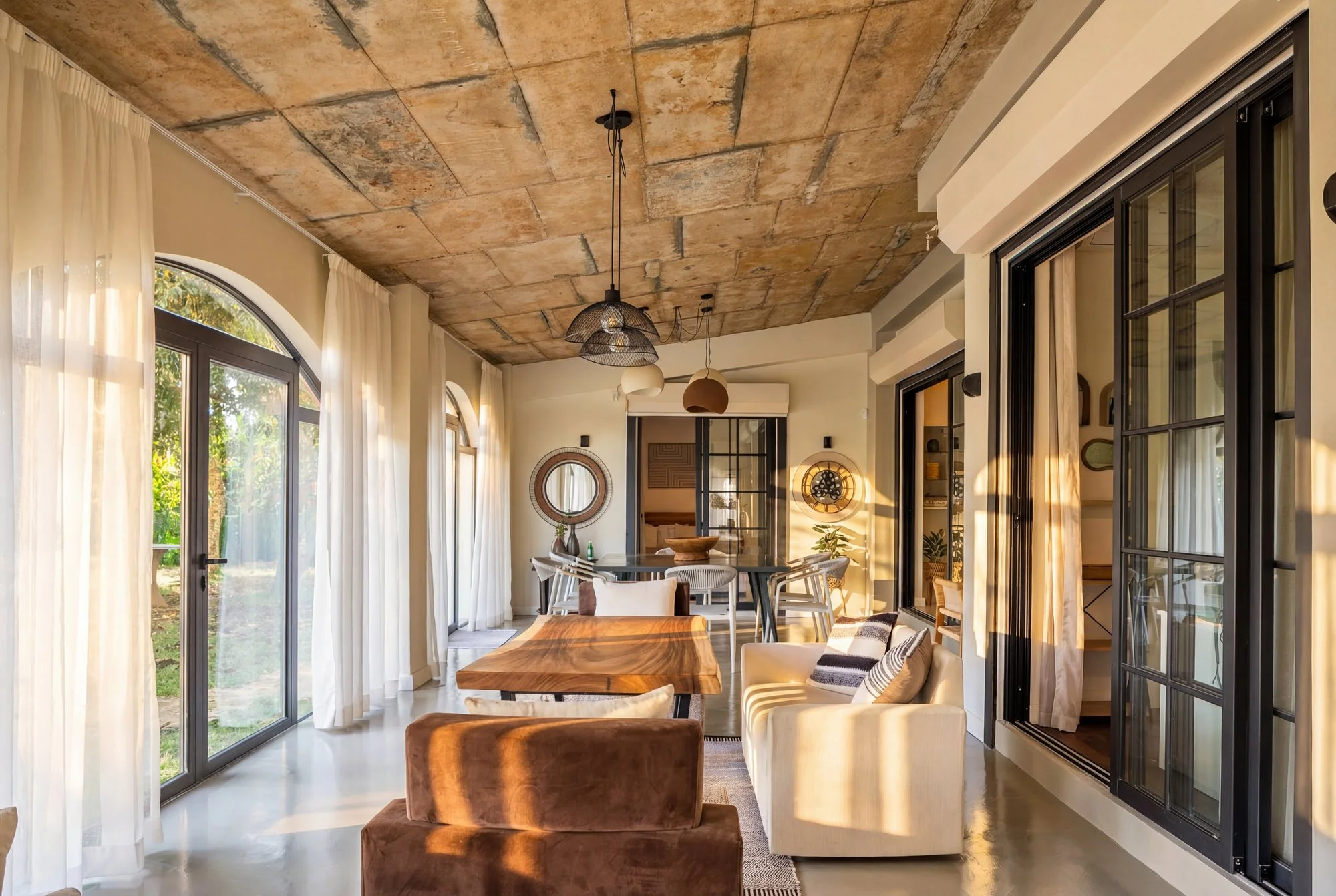 Moka House, Mauritius — arched veranda and exposed timber ceiling.