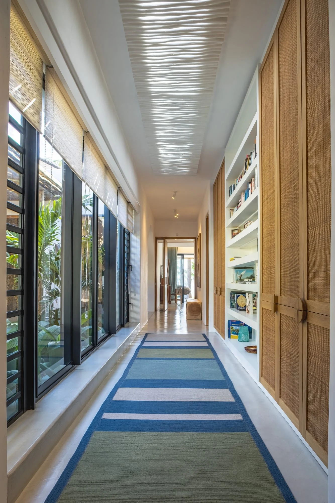 Muse Villa — long interior corridor with timber joinery and natural light.