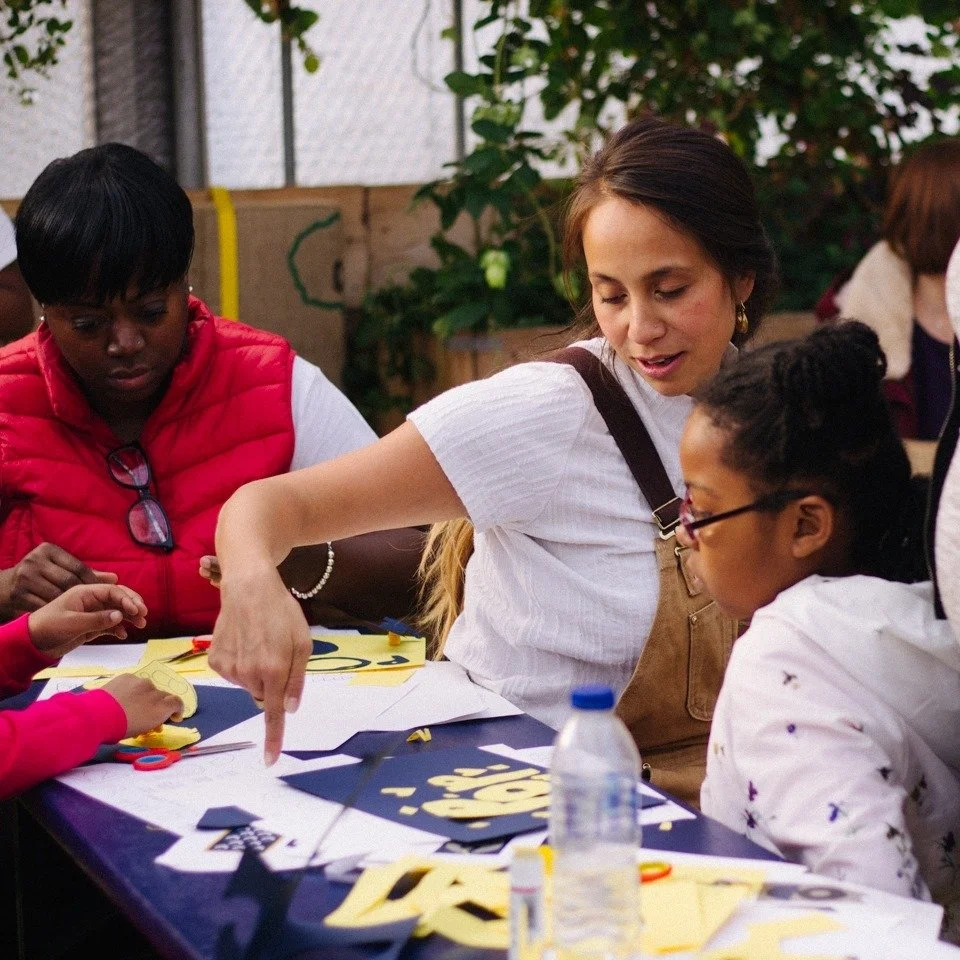 Women and children working together at an engagement event. Pop Brixton.