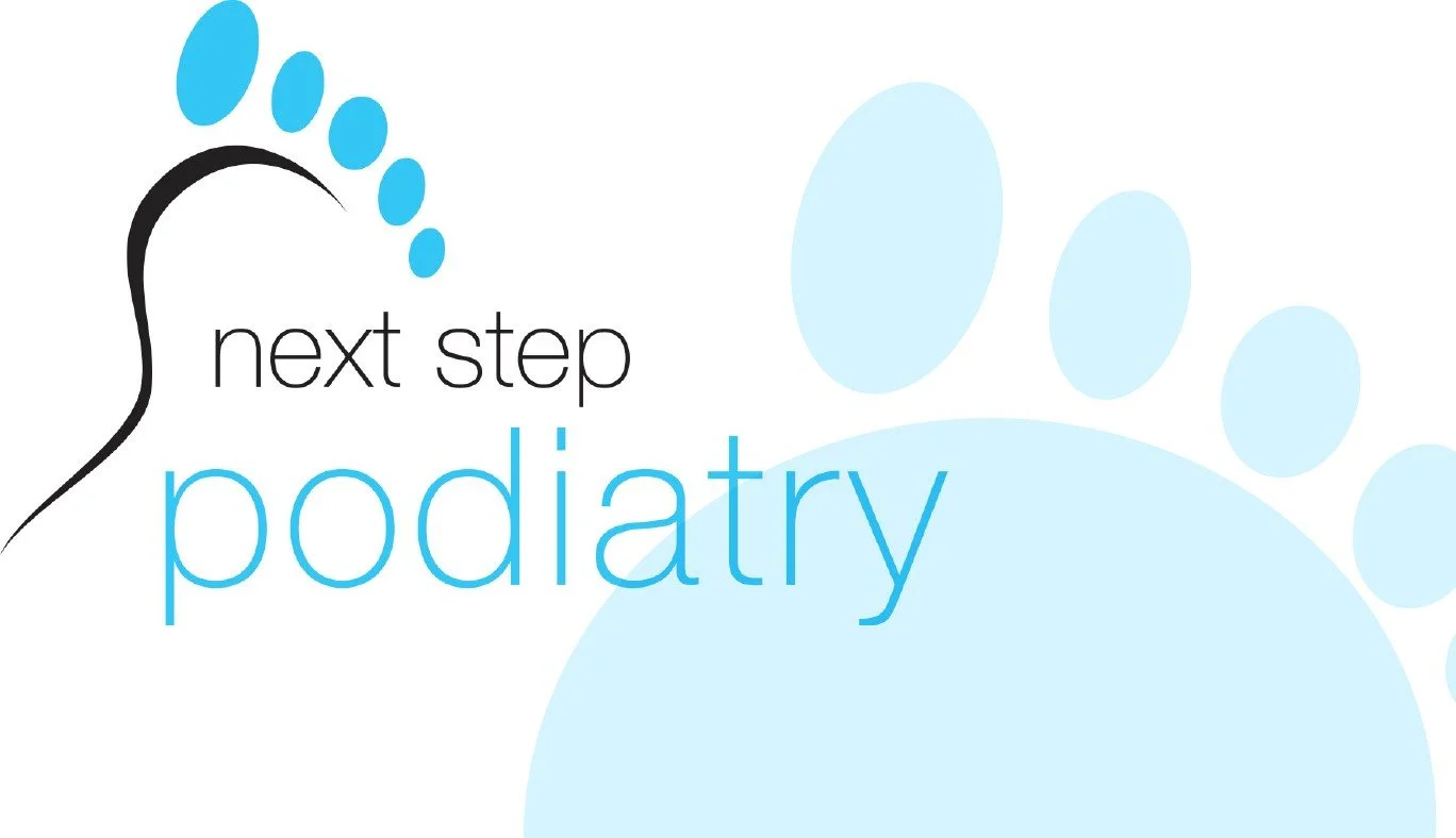 Logo with a large blue paw print, a black stylized footprint, and the text 'next step podiatry' in black and blue.