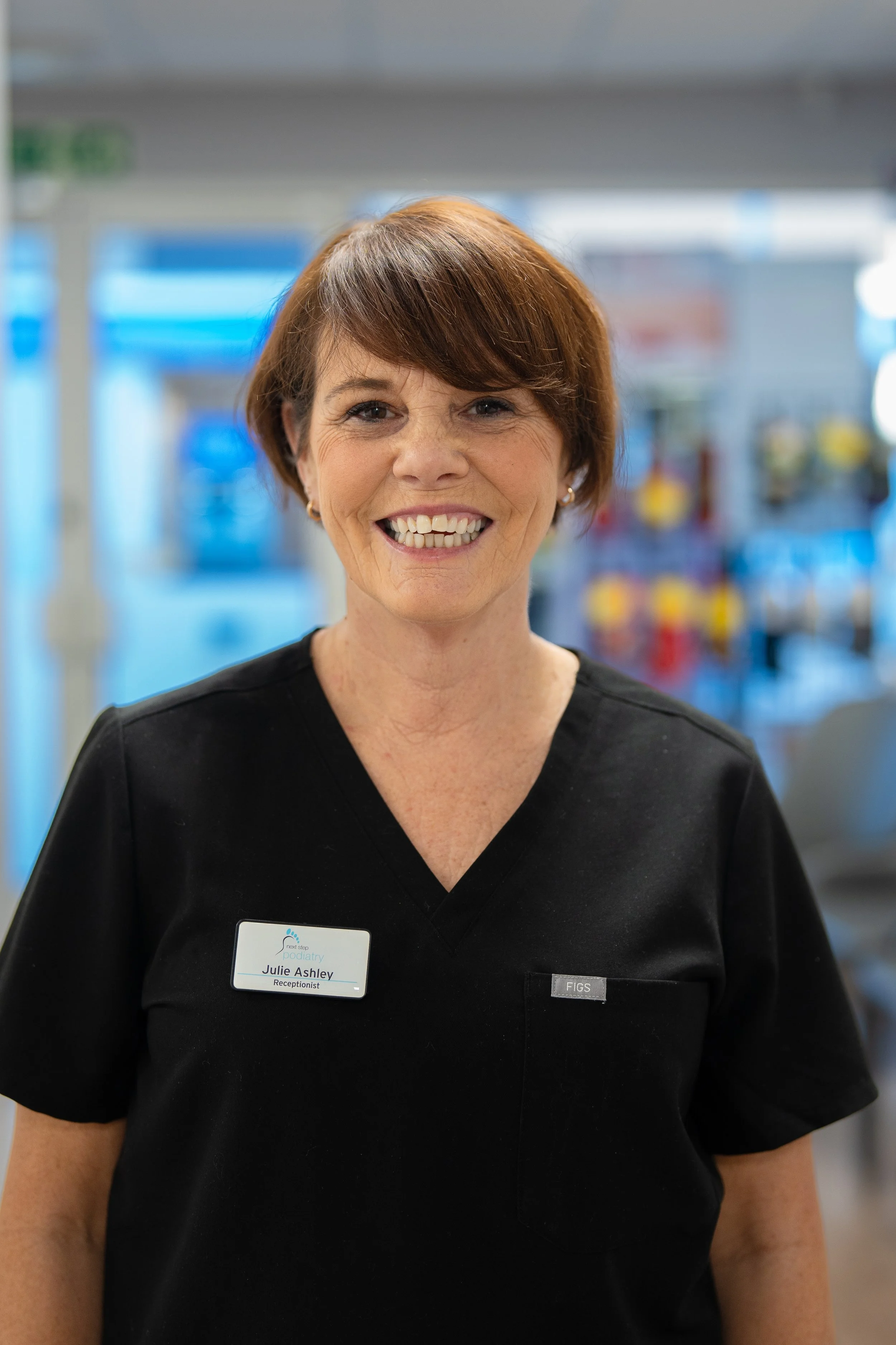 Julie Ashley, Receptionist welcoming patients to Next Step Podiatry.