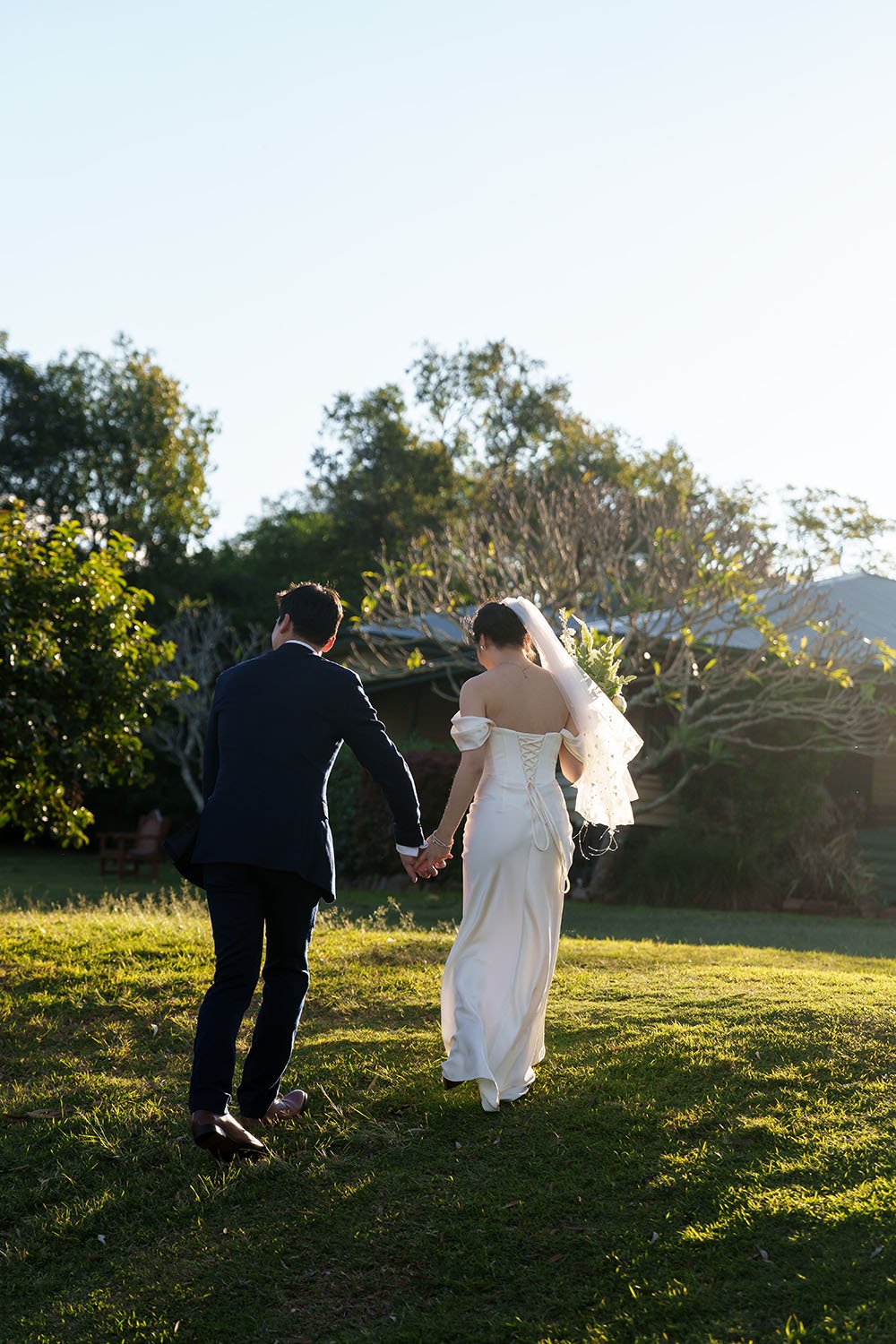 bride Flora leading groom Eric walking up the hill