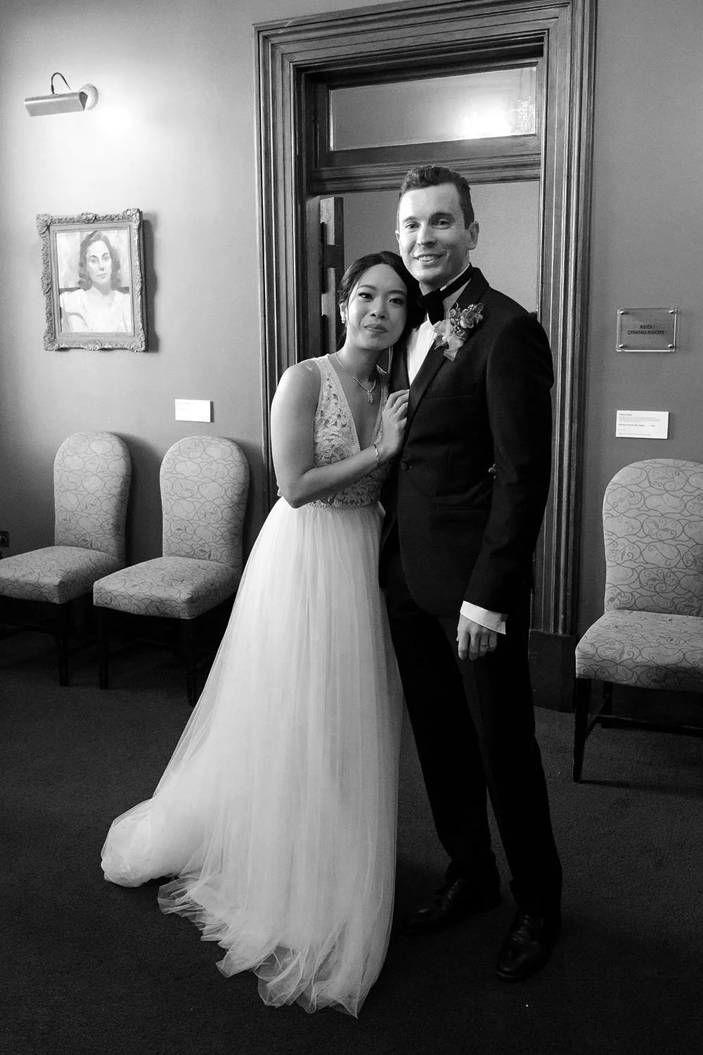 bride Cliffe leaning on groom Nori's chest, and they both look at the brisbane wedding photographer Whistler Li