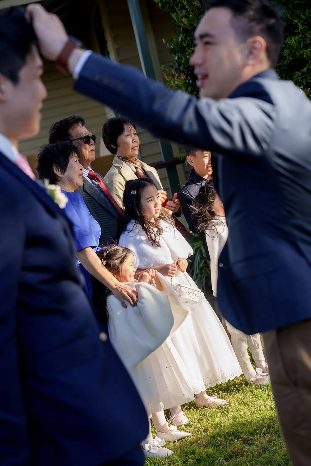 Eric's brother in law adjusting his hair, and background is another family members taking photos as well