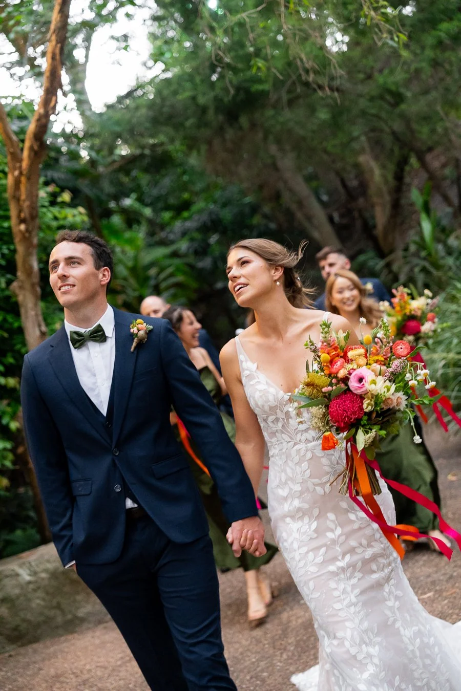bride and groom look up to the sky