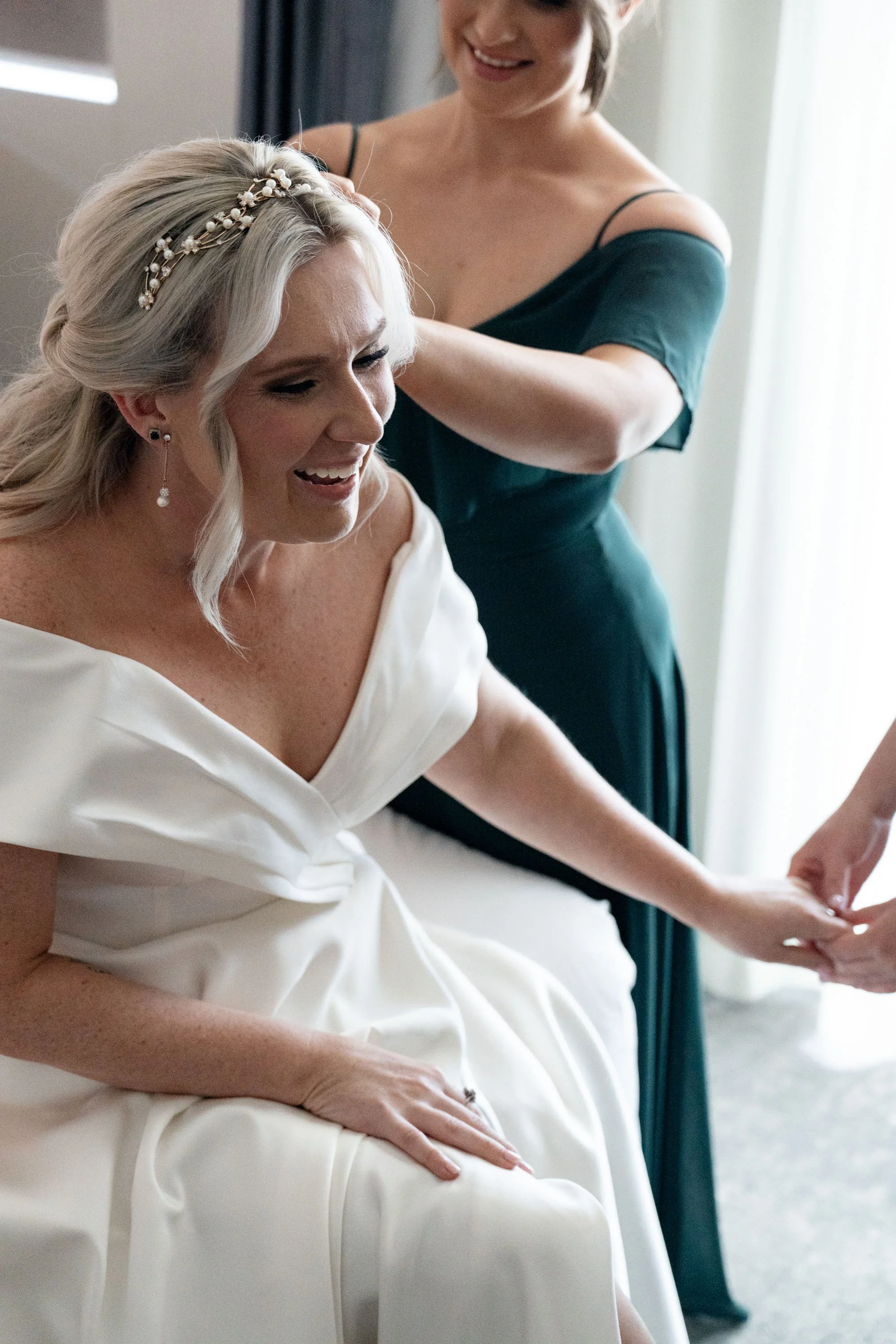 Bride Kyra laughing joyfully, her face radiating happiness and excitement on her wedding day