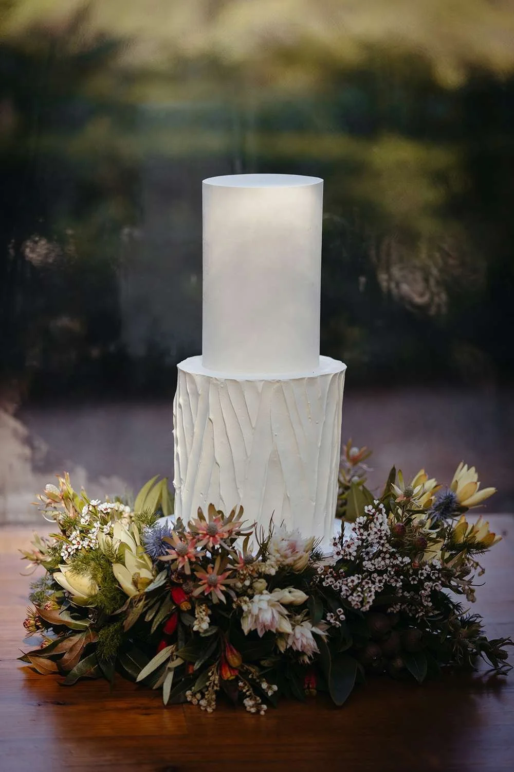 wedding cake and flower at the bottom surrounding it