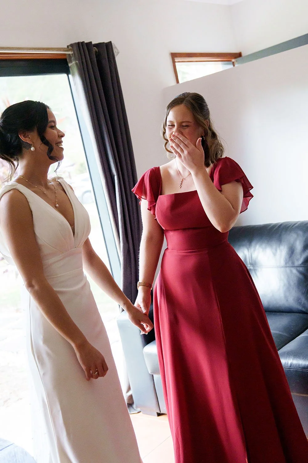 maid of honour Mel almost crying with one hand cover her face