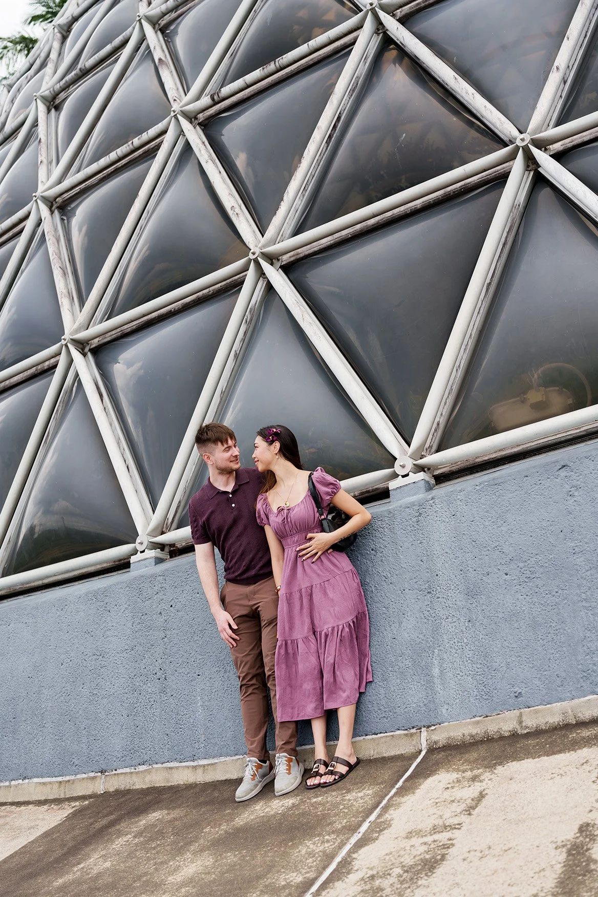 They leaned against the Tropical Dome wall together.