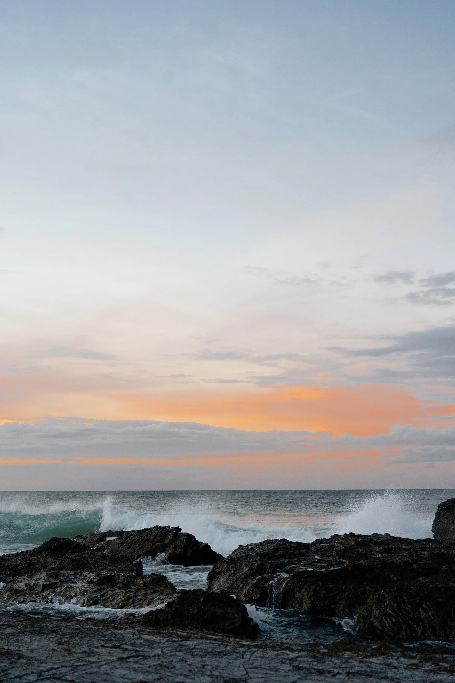 Ocean waves, rock and sunset in Gold Coast