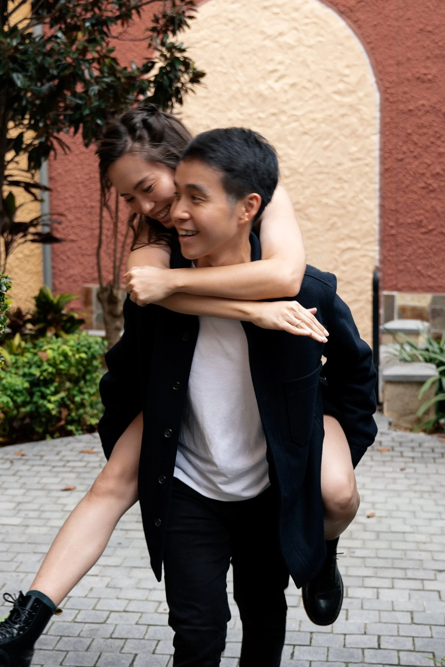 Paul carrying Krystel and they both laughs in Emerald Lakes Village