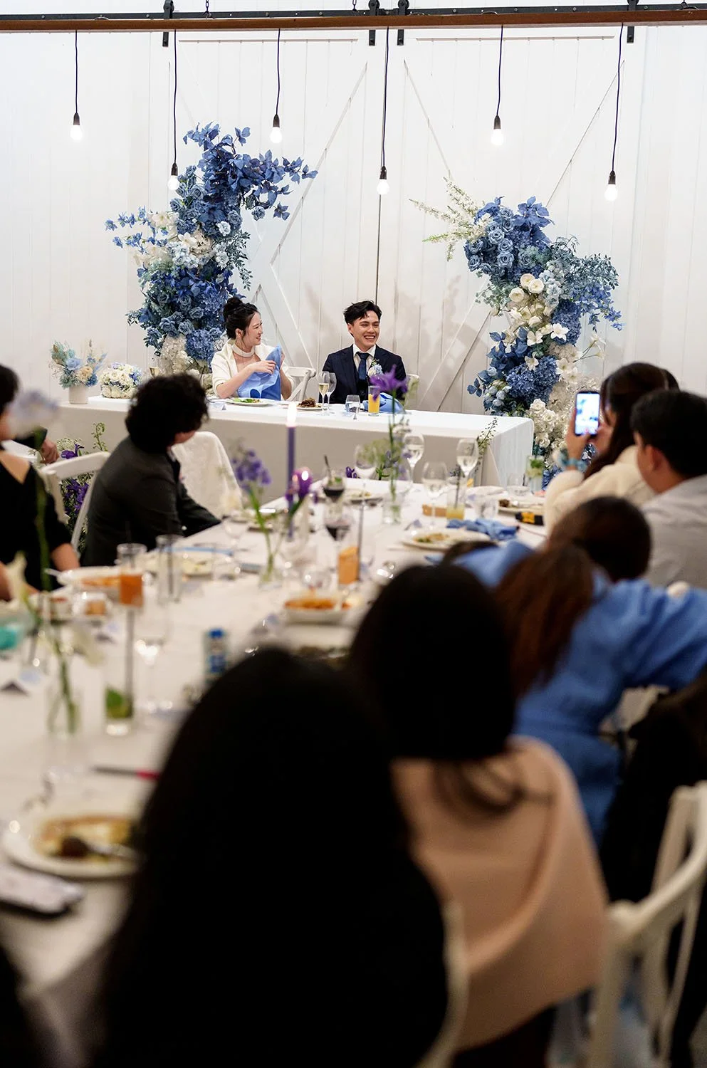 Lisa and Michael sitting back their bridal table smell during speech