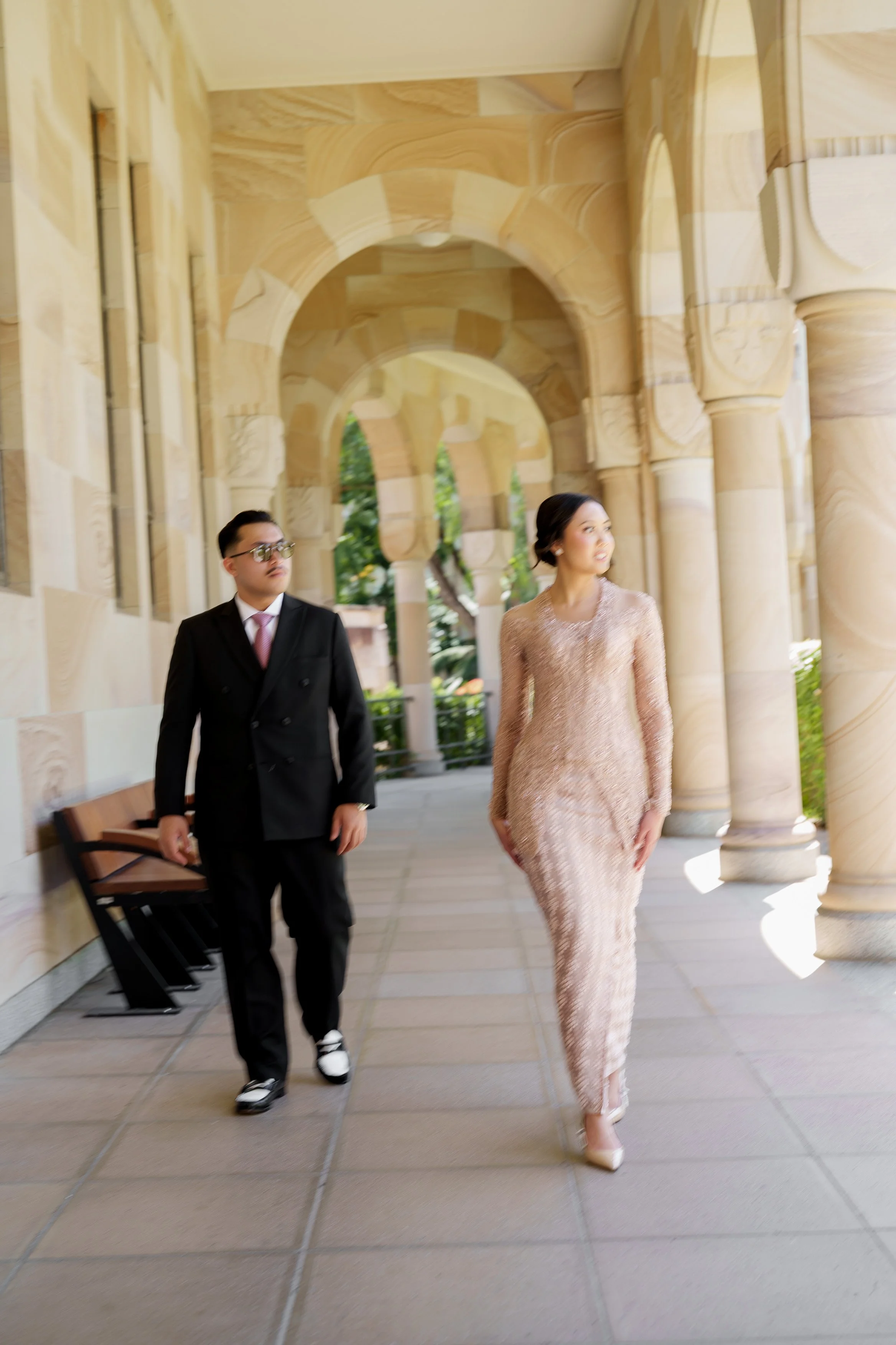 Bella and Aka walking while they look outside the Great Hall