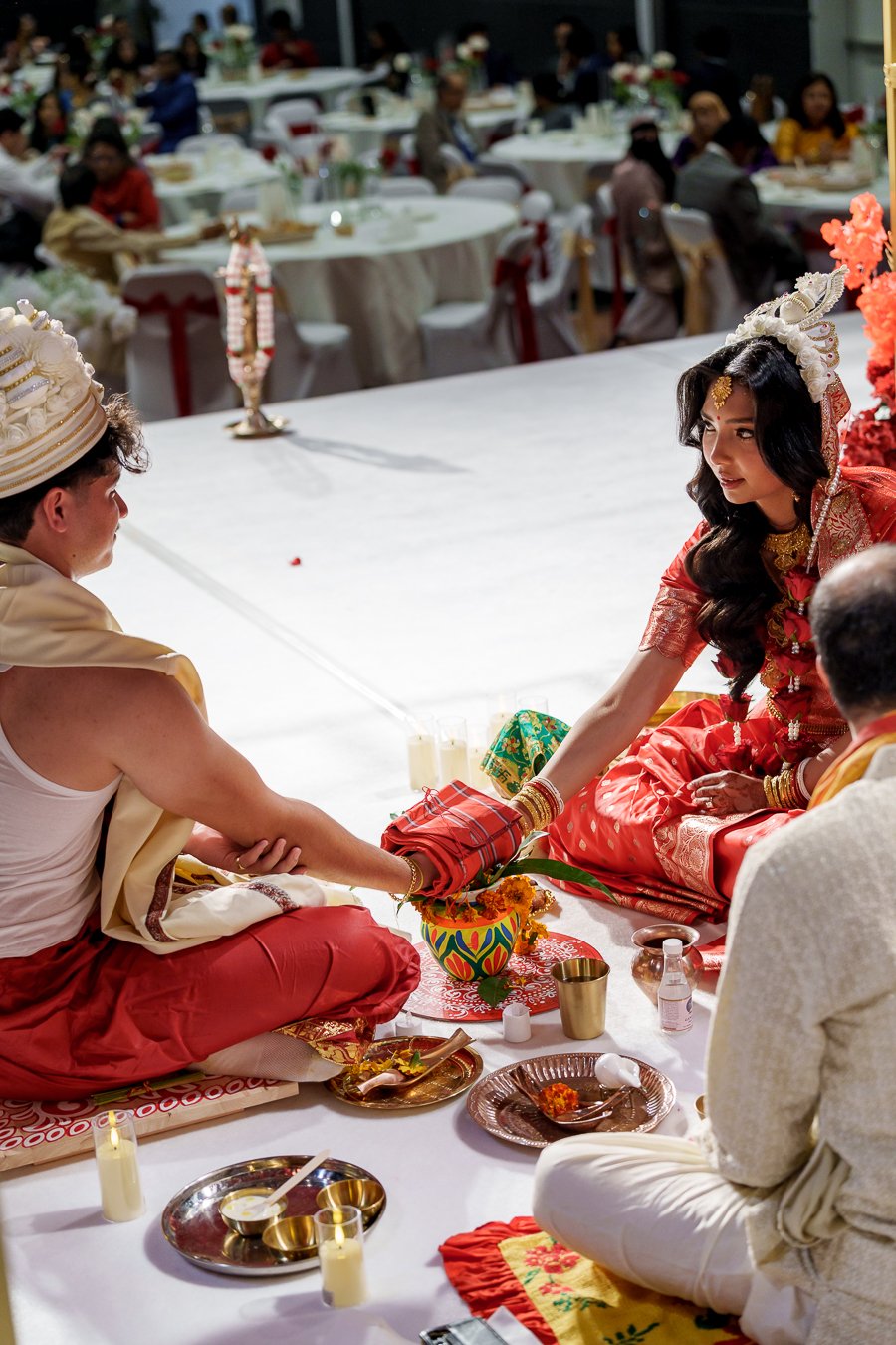 Amrita and Casey sit facing to each other and look to each other
