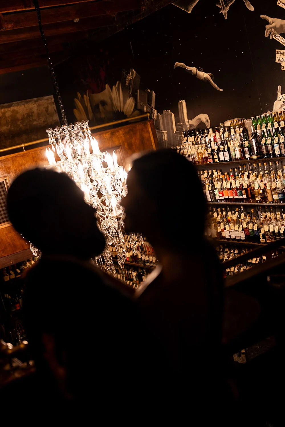 bright chandelier and wine bottles at the background