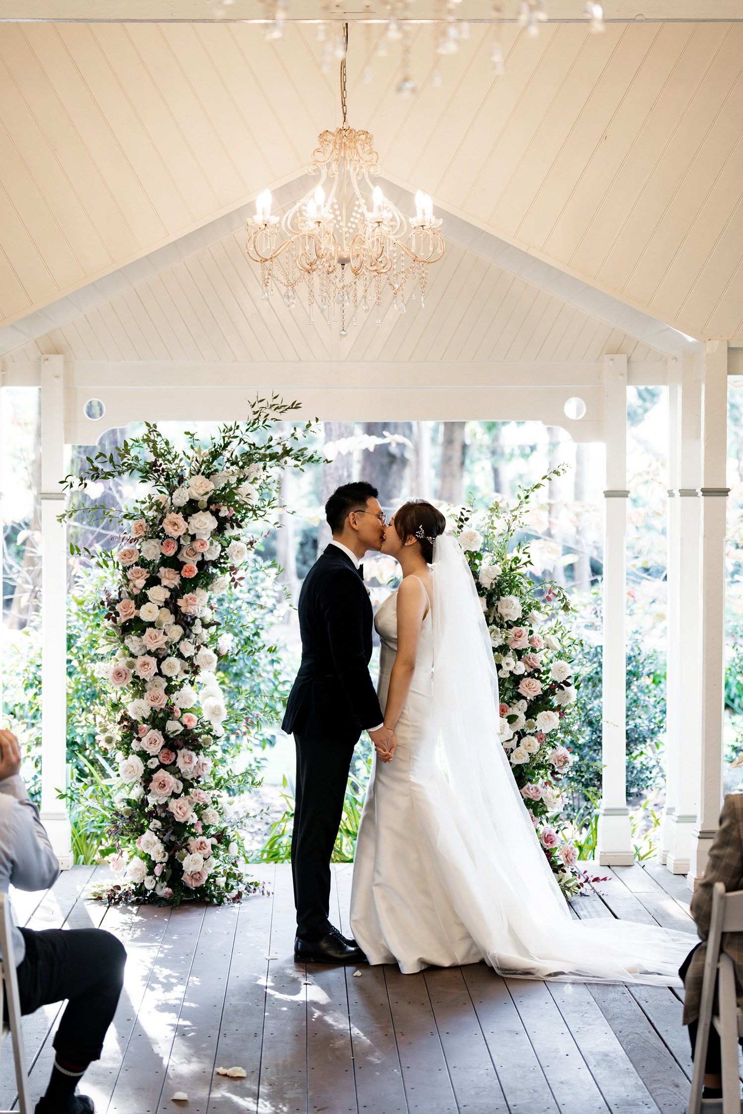 bride and groom share their first kiss in wedding ceremony