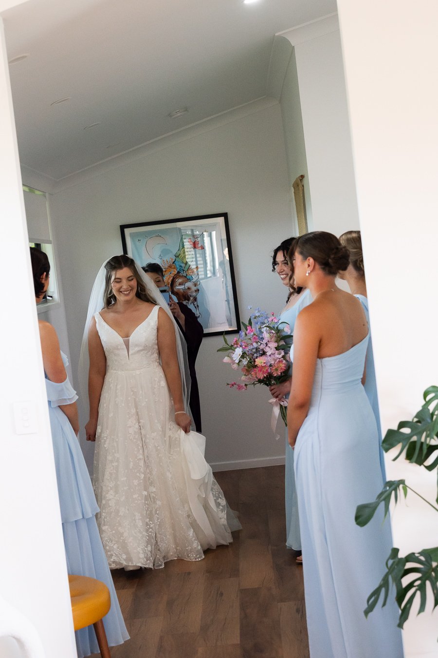 bride Chiarra walking out of the room and surprise the bride mates