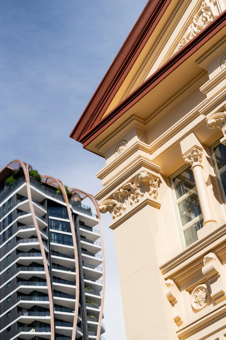 A corner of the St Mary's Catholic Church outside the church with modern apartment buildings in the distance.