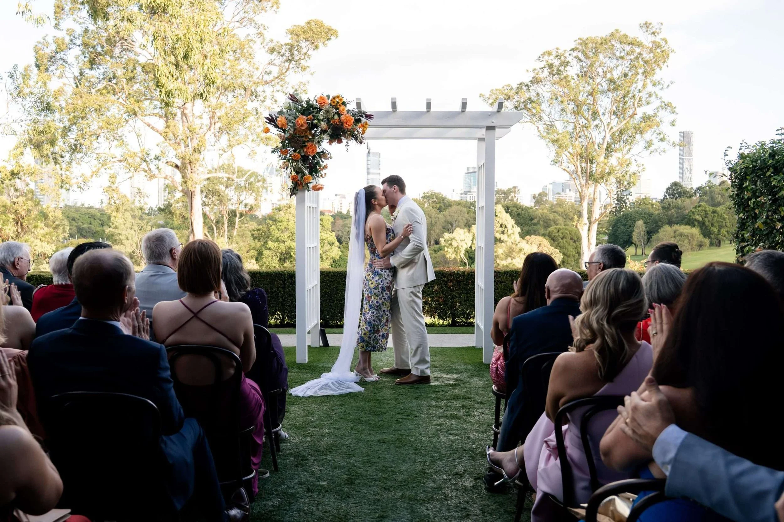 bride and groom share their fist kiss iduring the wedding ceremony