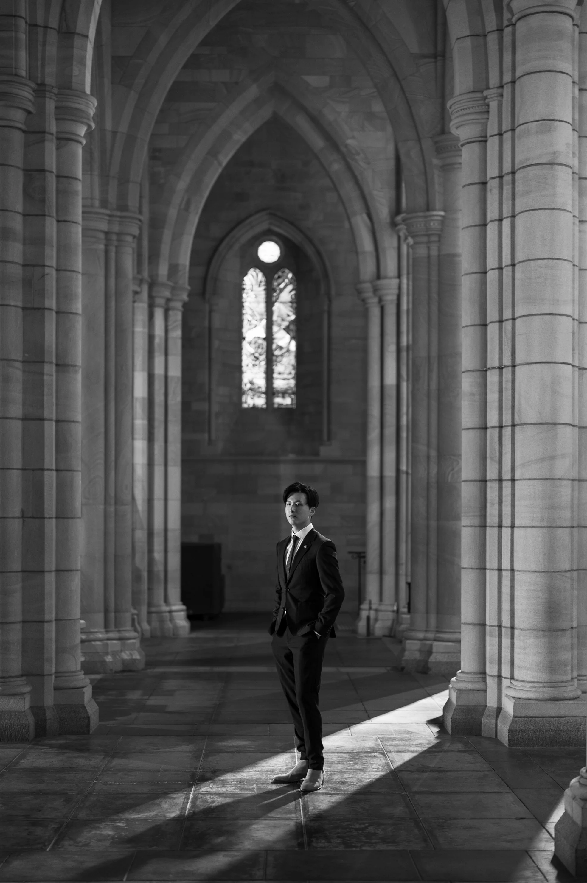 groom herself standing in black and white colour in St John's Cathedral in Brisbane