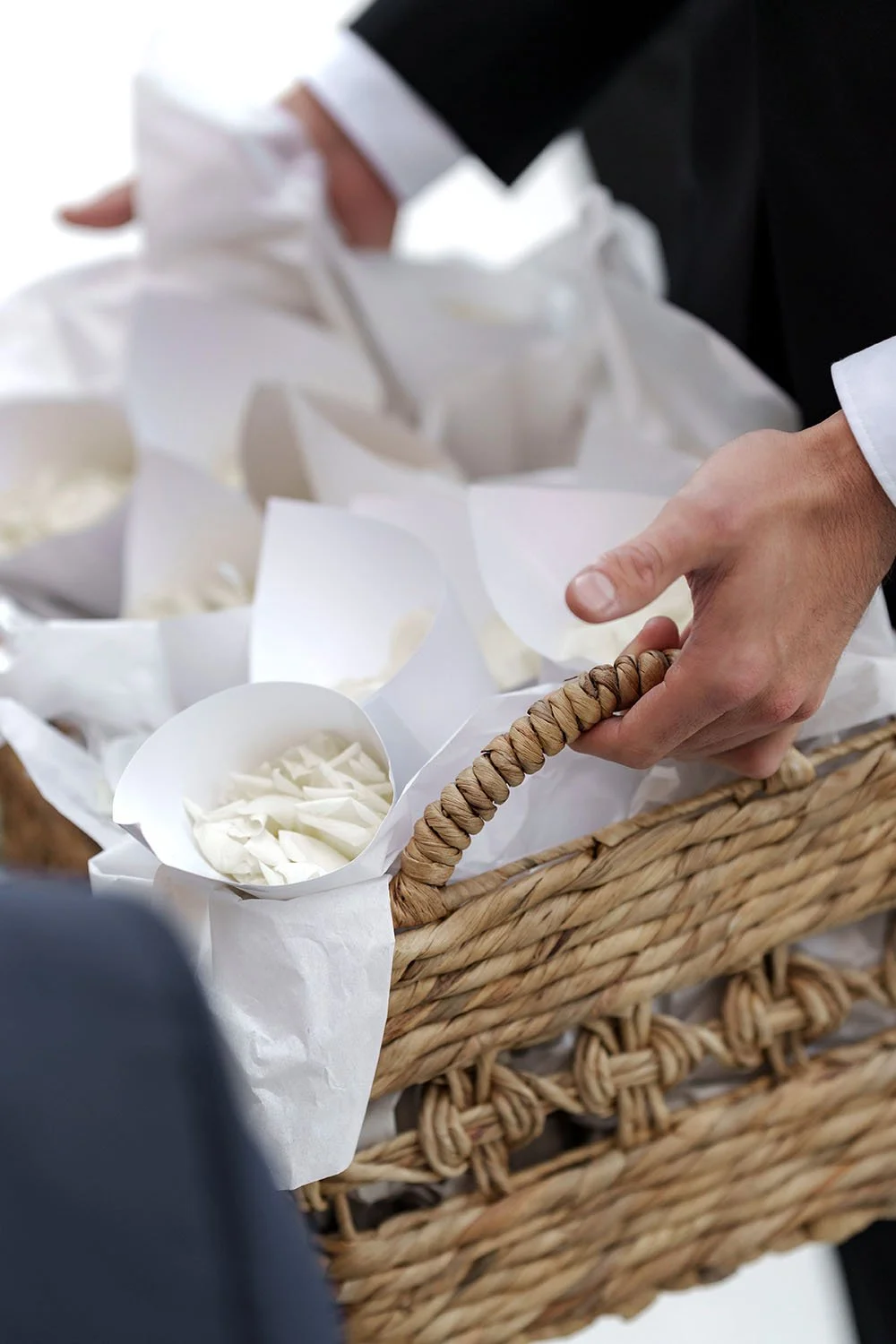 The groomsmen holding flower petals and sharing them with the guests
