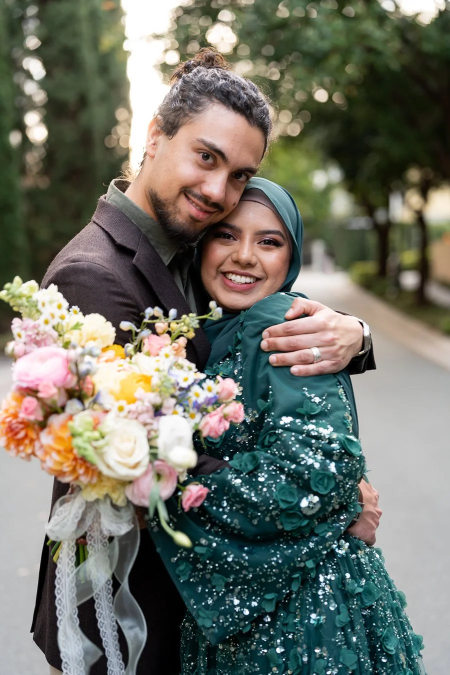 Junaid holding Affifah very tight and they both look at Whistler Li