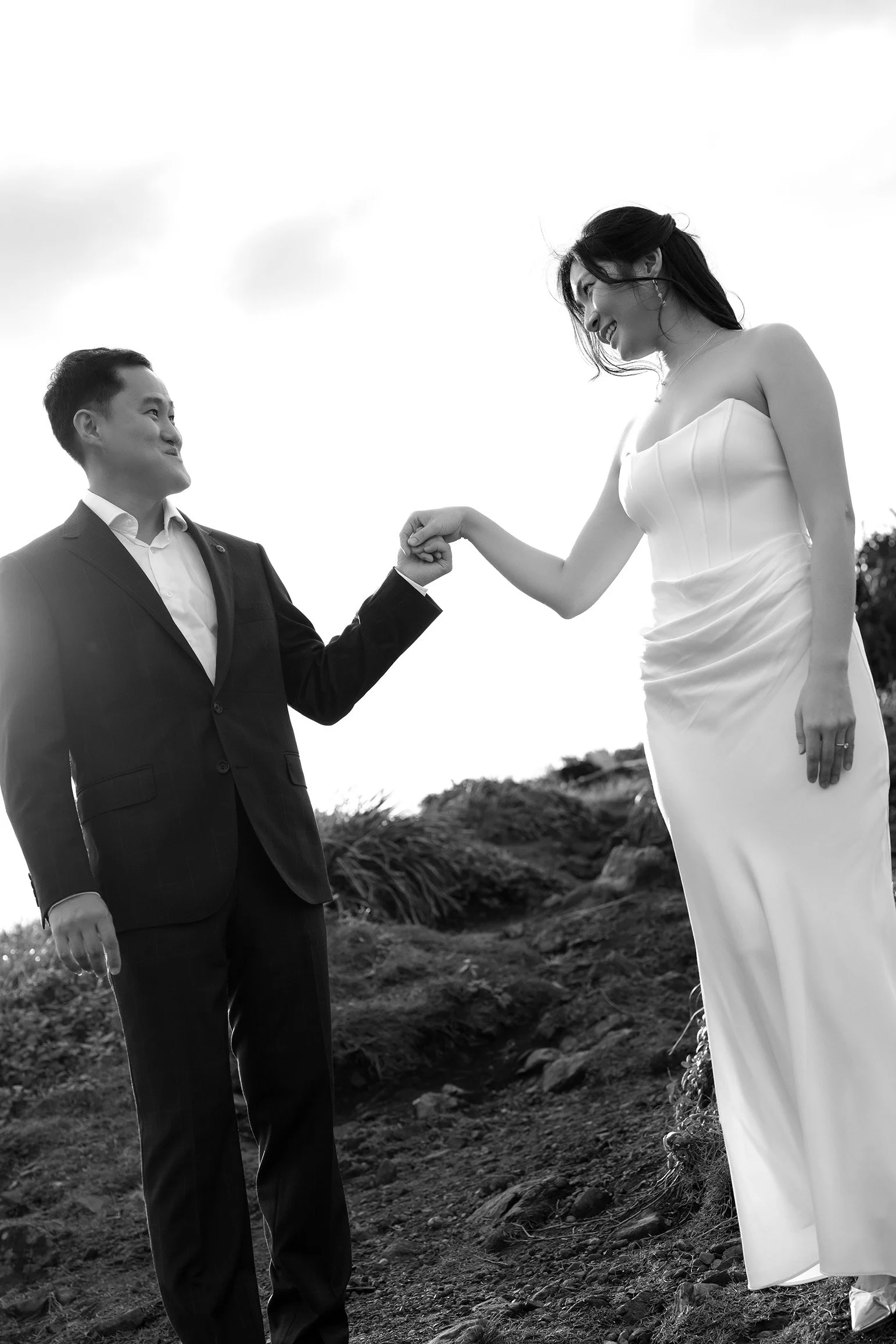 Silva holding Margaret's hand with their eyes look at each other and sunlight behind them
