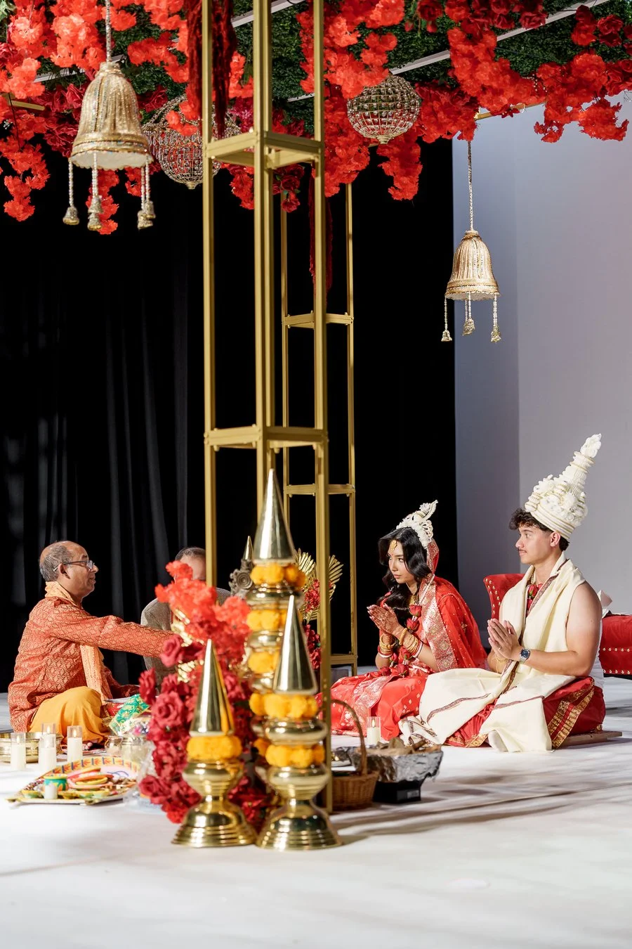 priest introduce some ceremony progress to Amrita and Casey