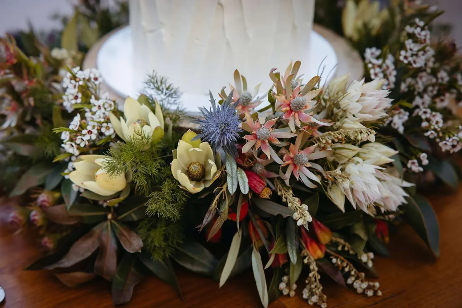 wedding cake and flower at the bottom surrounding it